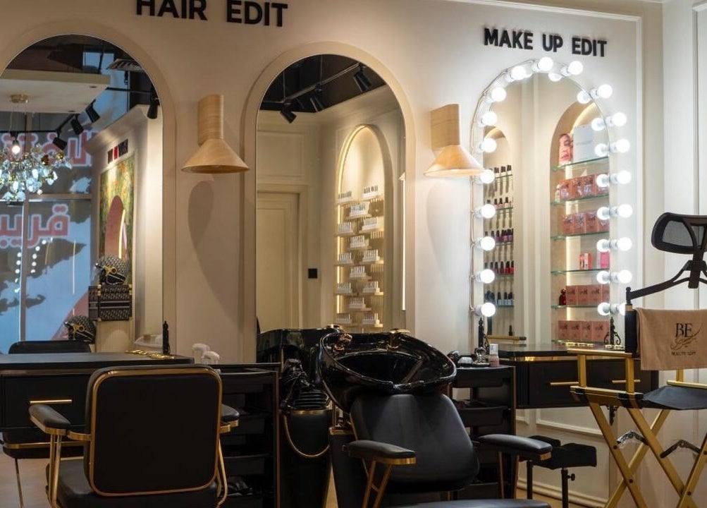 Inside Beauty Edit Dubai, a chic salon in Dubai, AE with elegant styling stations and illuminated mirrors.