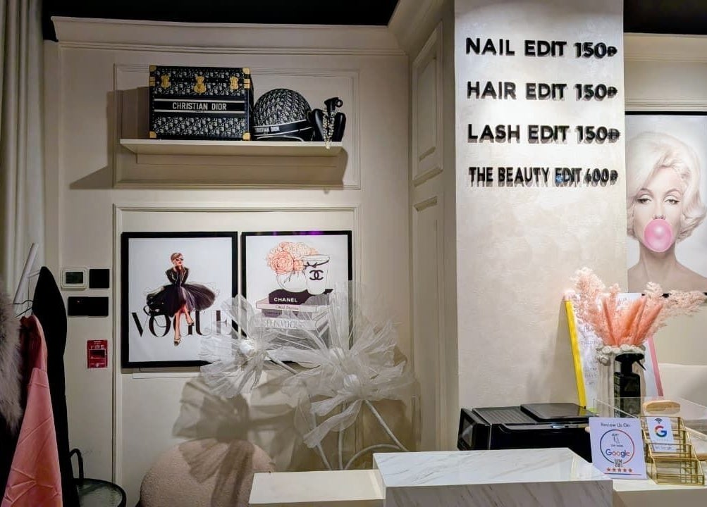 Stylish front desk at Beauty Edit Dubai featuring elegant decor and service menu, located in Dubai, AE.