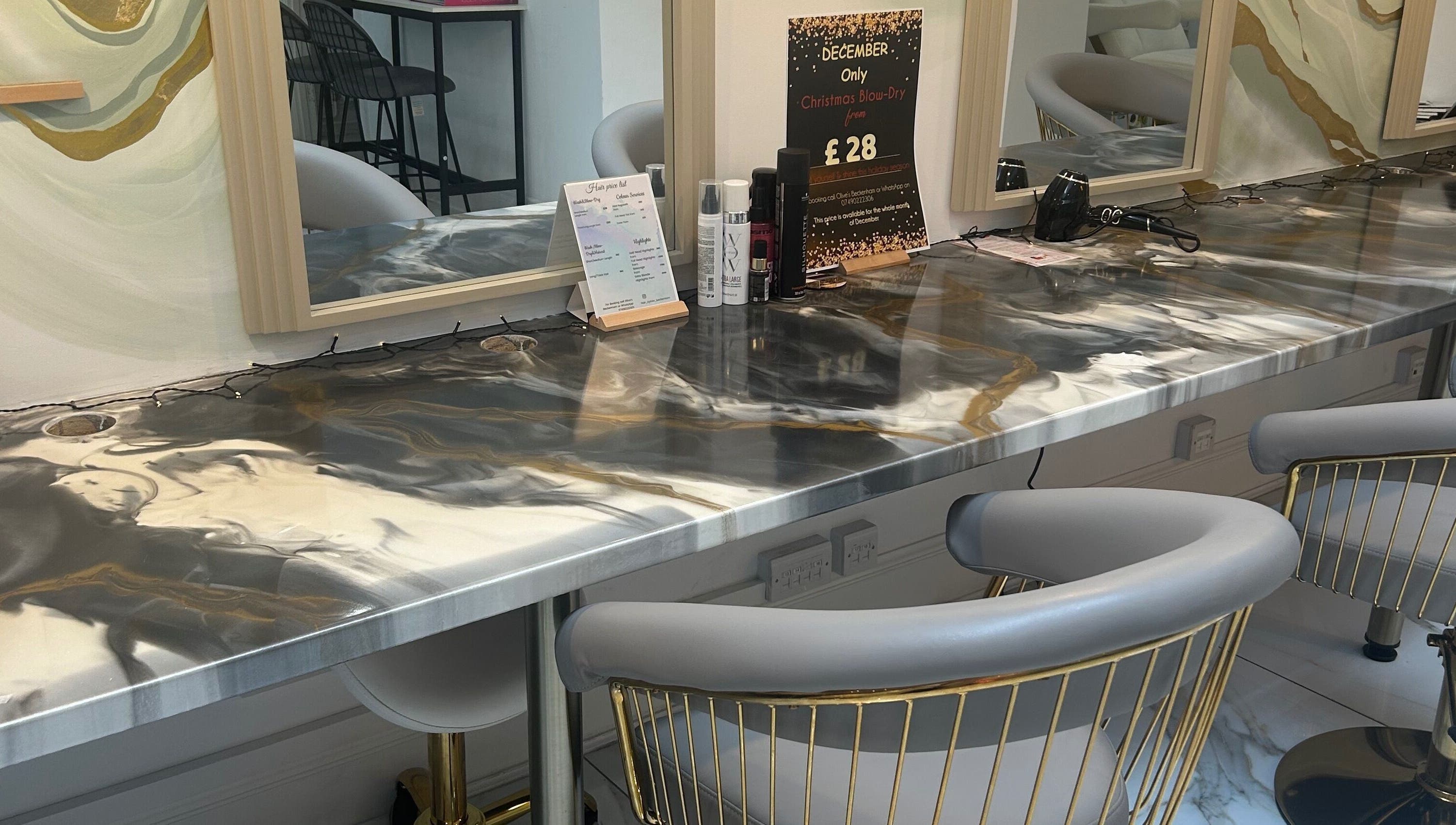 Modern hair styling station at Lola’s Hair, Beckenham, England, GB with elegant chairs and a stylish countertop.