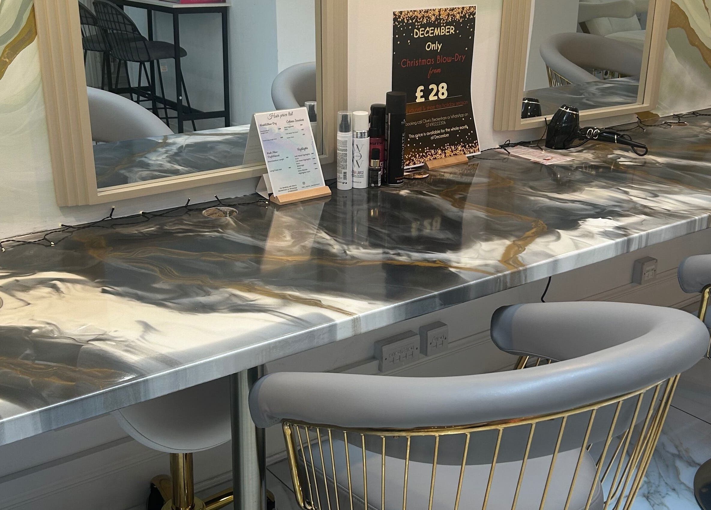 Modern hair styling station at Lola’s Hair, Beckenham, England, GB with elegant chairs and a stylish countertop.