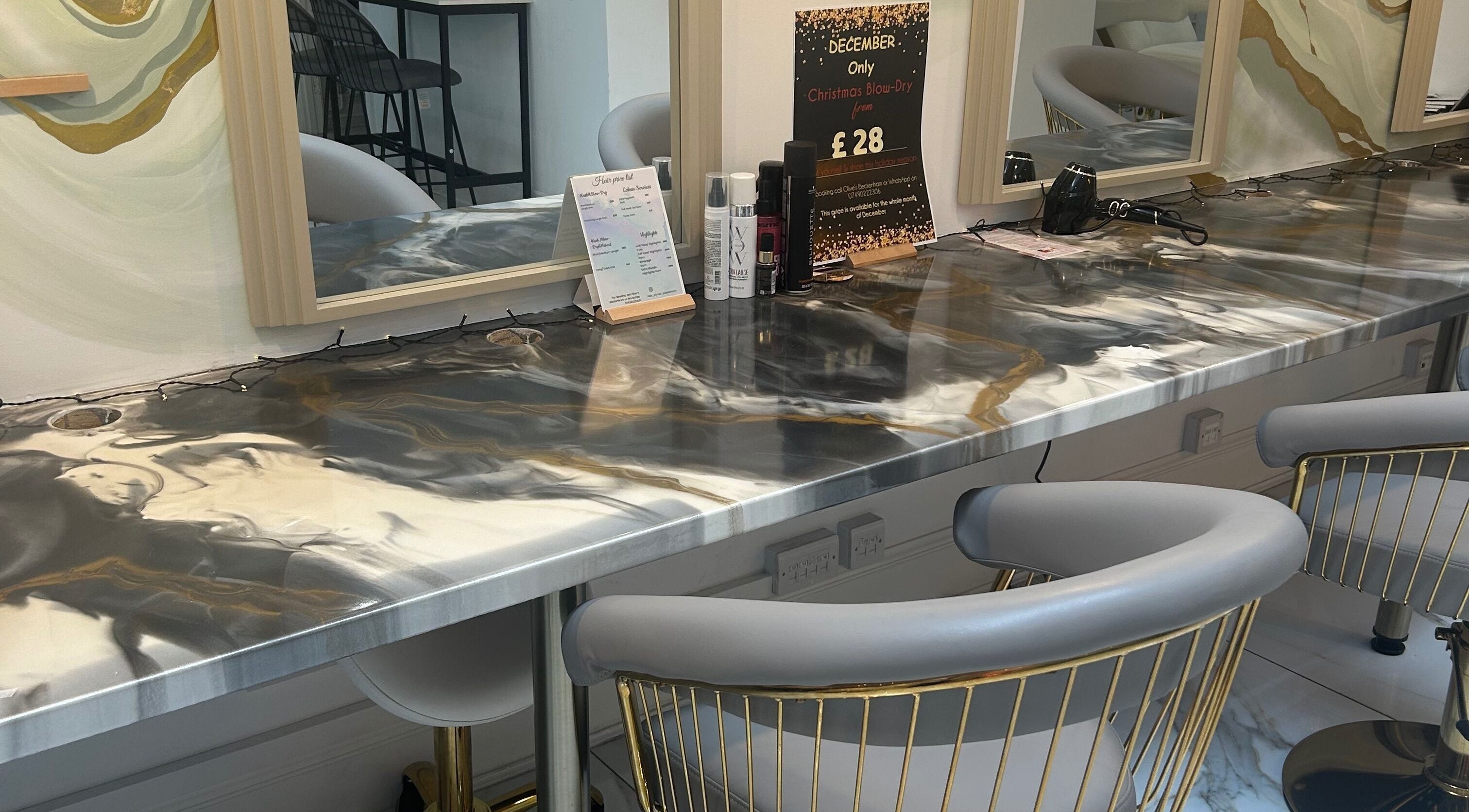 Modern hair styling station at Lola’s Hair, Beckenham, England, GB with elegant chairs and a stylish countertop.