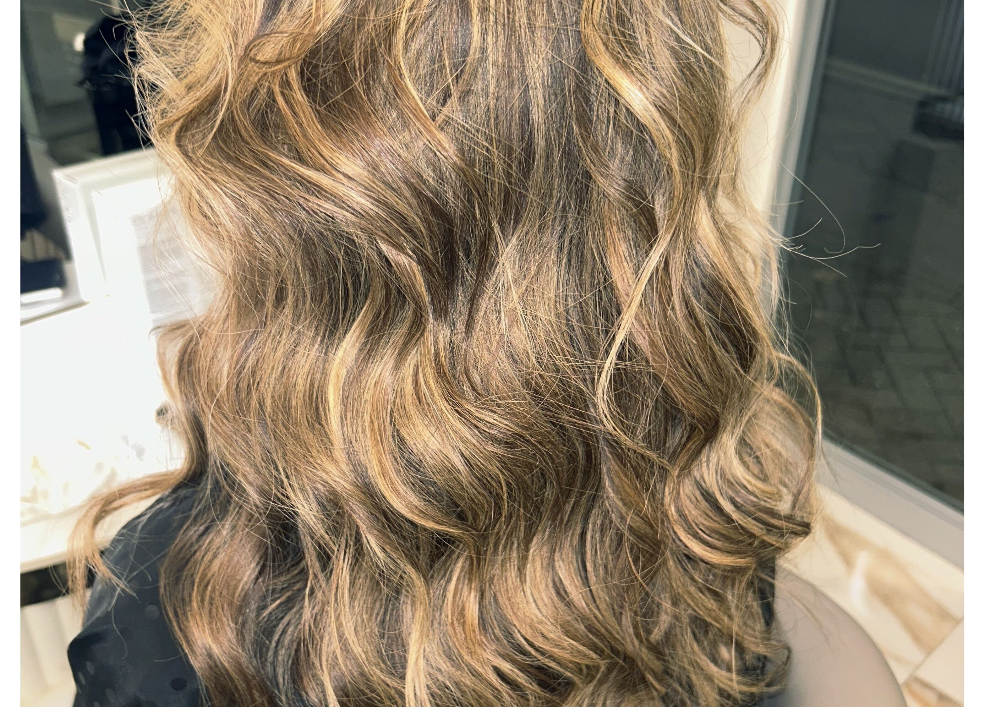 Luscious golden waves styled at Lola’s Hair, Beckenham, England, GB for a stunning look.