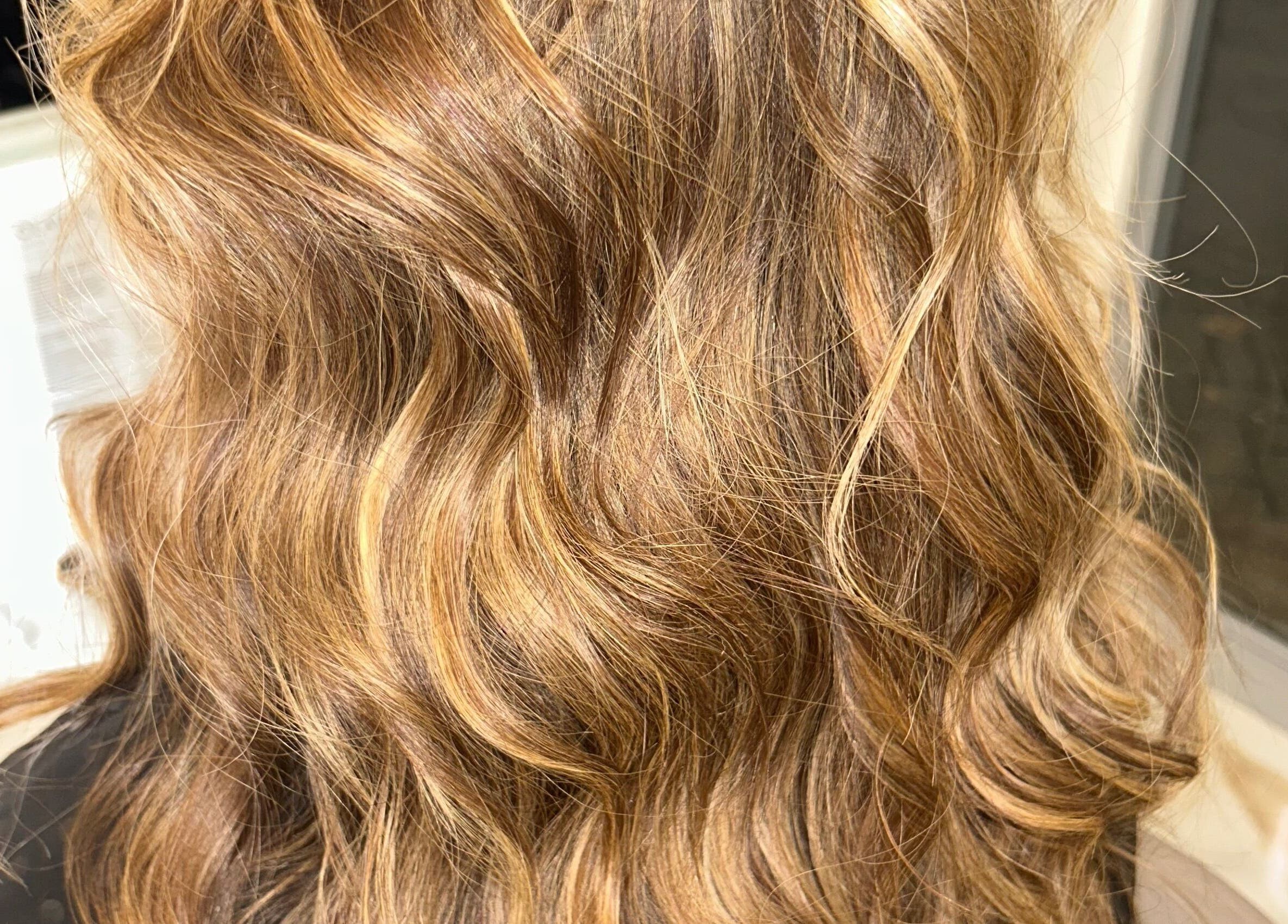 Close-up of wavy golden hair at Lola’s Hair, Beckenham, England, GB.