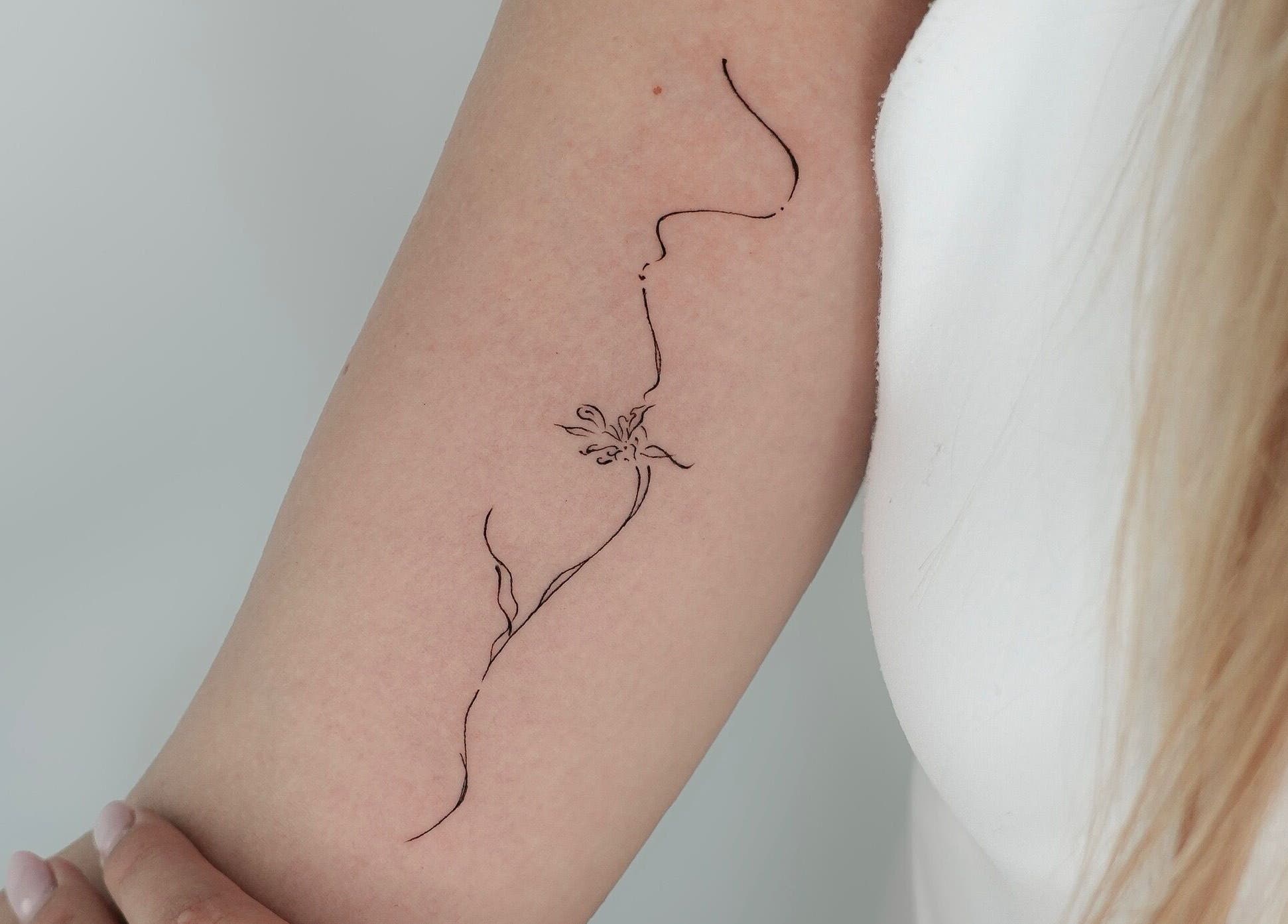 Elegant floral tattoo on arm at Belle Amé Room, Zürich, Zürich, CH. Delicate artistry in a serene setting.