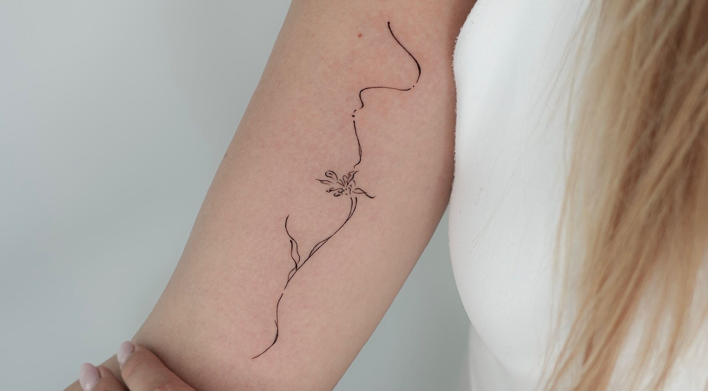 Delicate floral tattoo on arm at Belle Amé Room, Zürich, Zürich, CH, showcasing intricate linework.