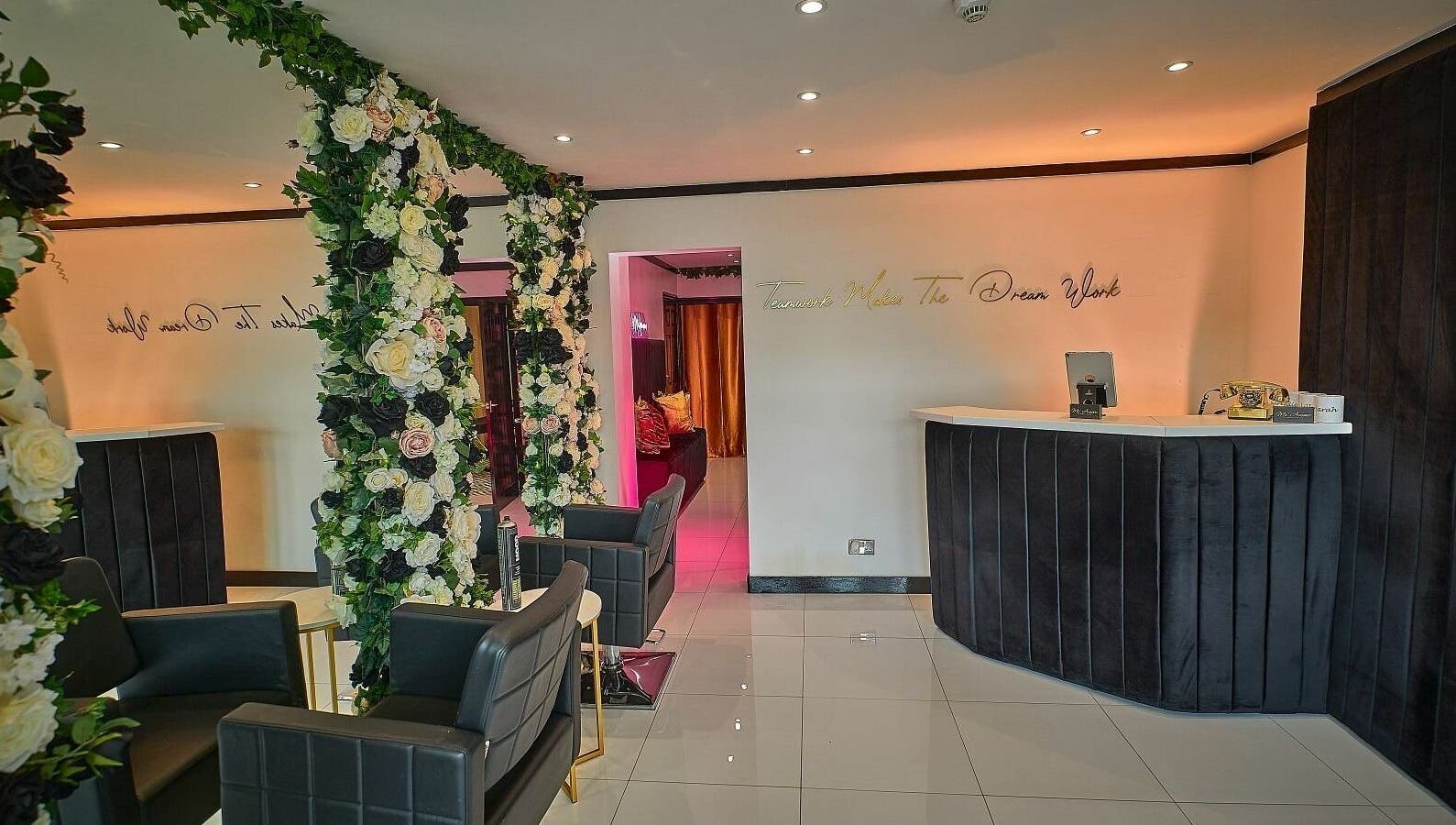 Elegant reception area at Mi Amour, Audenshaw, England, adorned with luxurious floral arrangements.