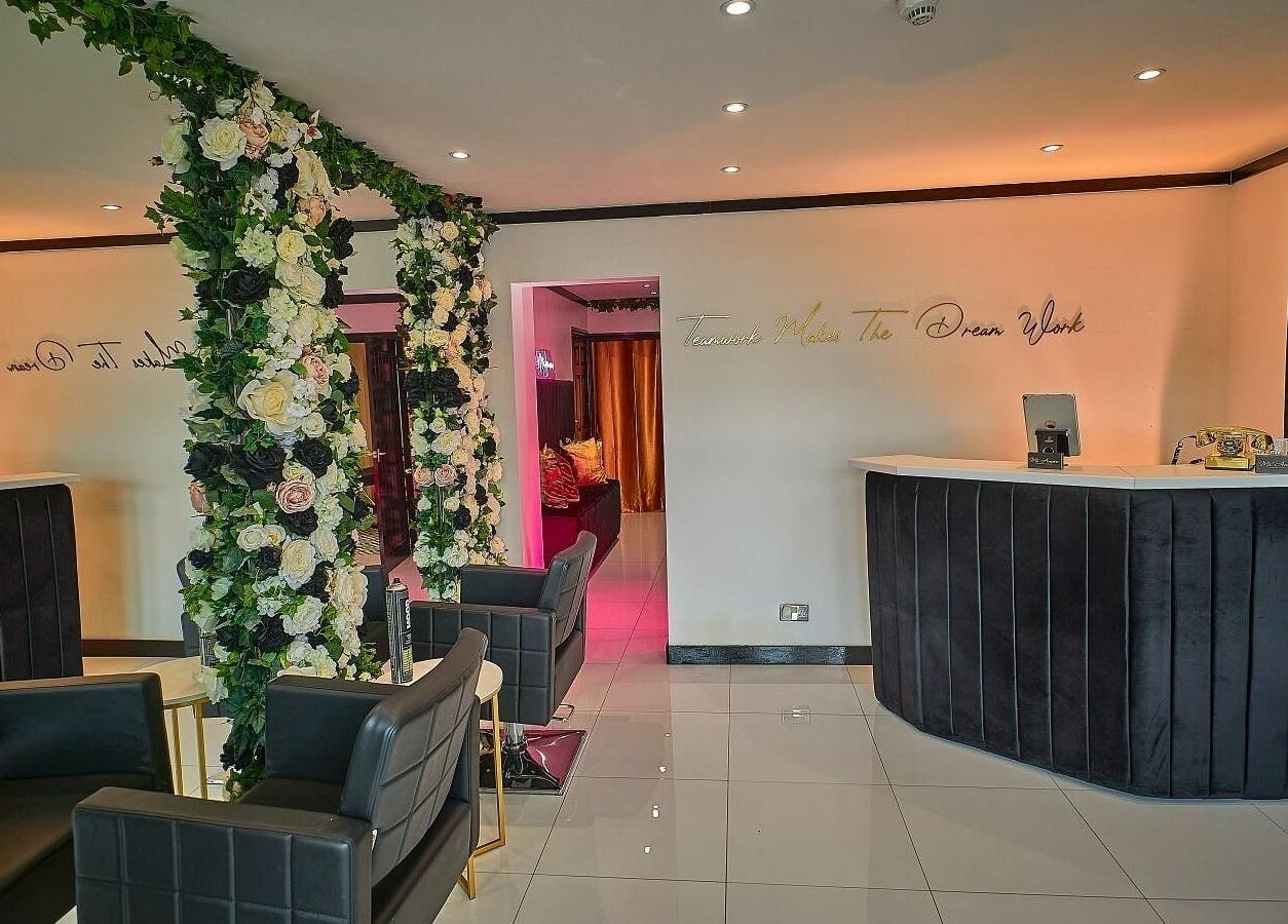 Elegant reception area at Mi Amour, Audenshaw, England, adorned with luxurious floral arrangements.