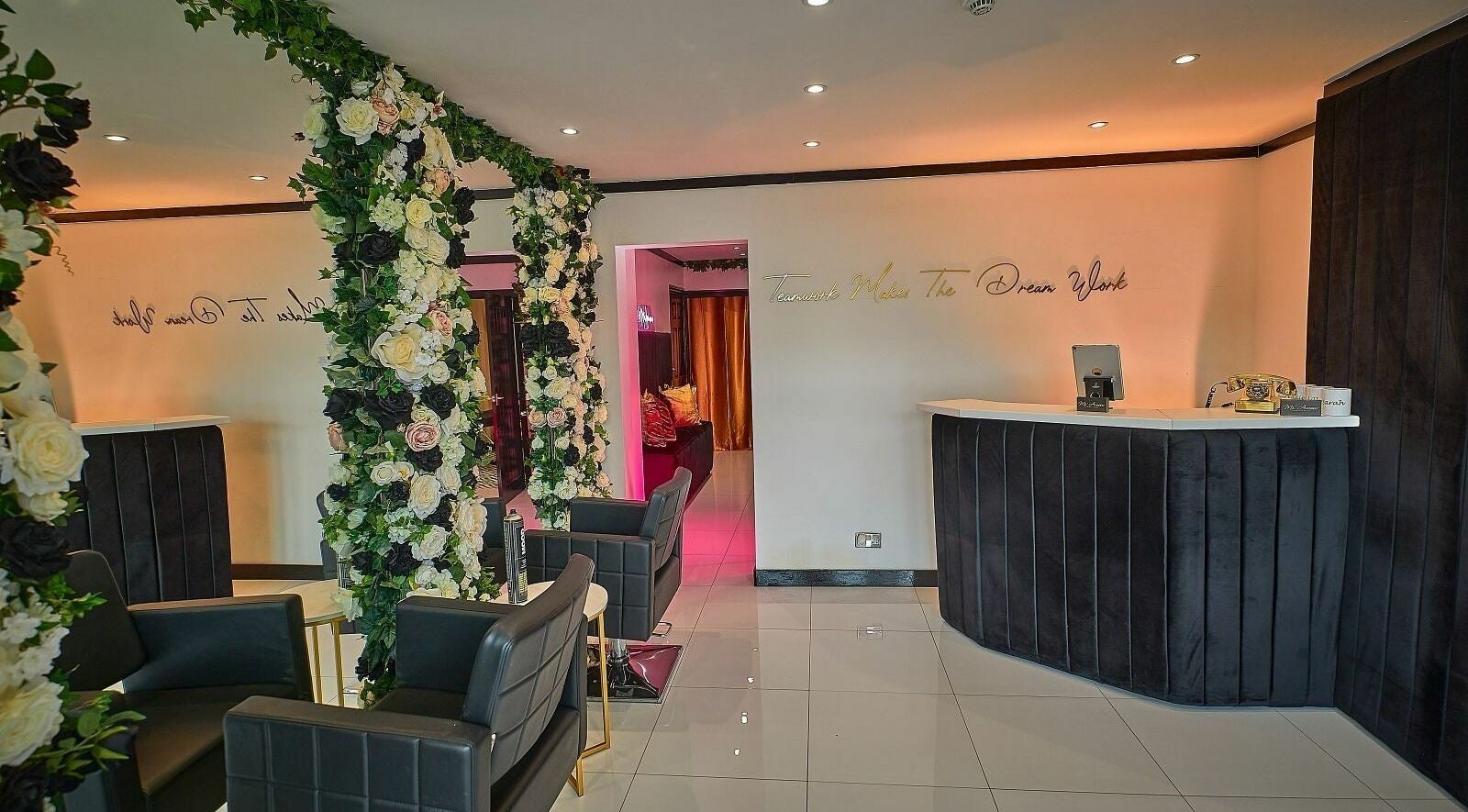 Elegant reception area at Mi Amour, Audenshaw, England, adorned with luxurious floral arrangements.
