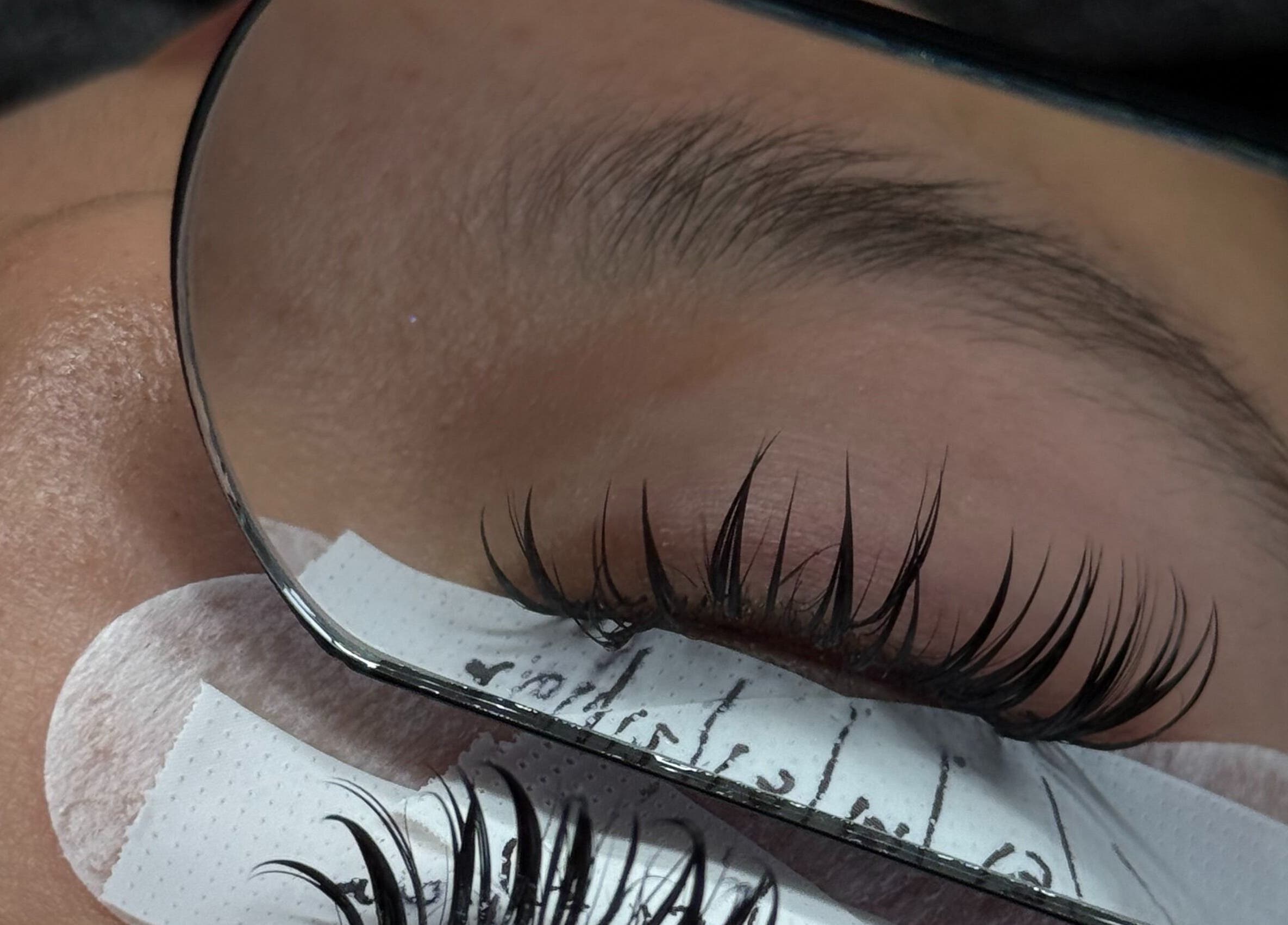 Expert eyelash extension application at PHXLASH, London, England, GB with precision and care.