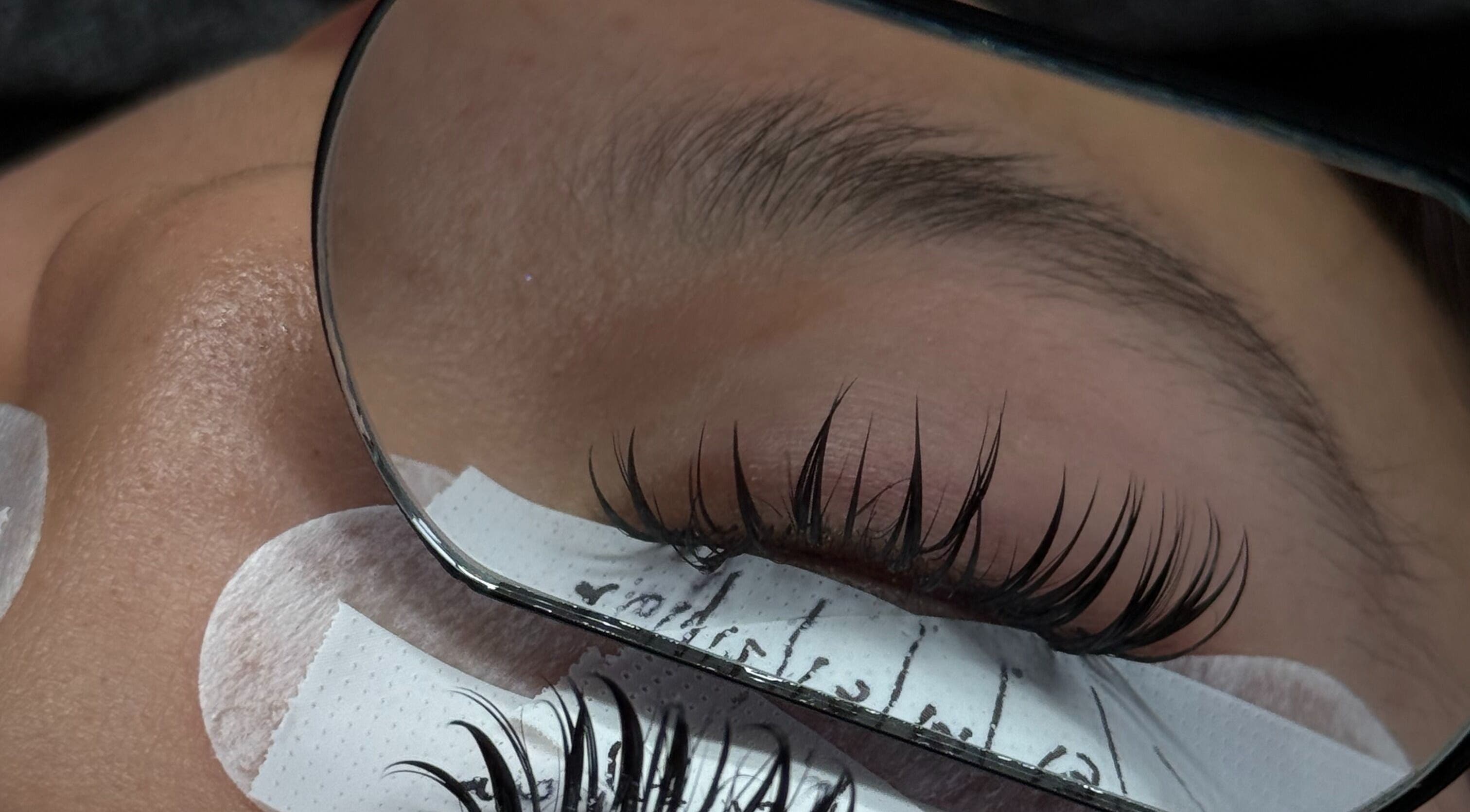Expert eyelash extension application at PHXLASH, London, England, GB with precision and care.