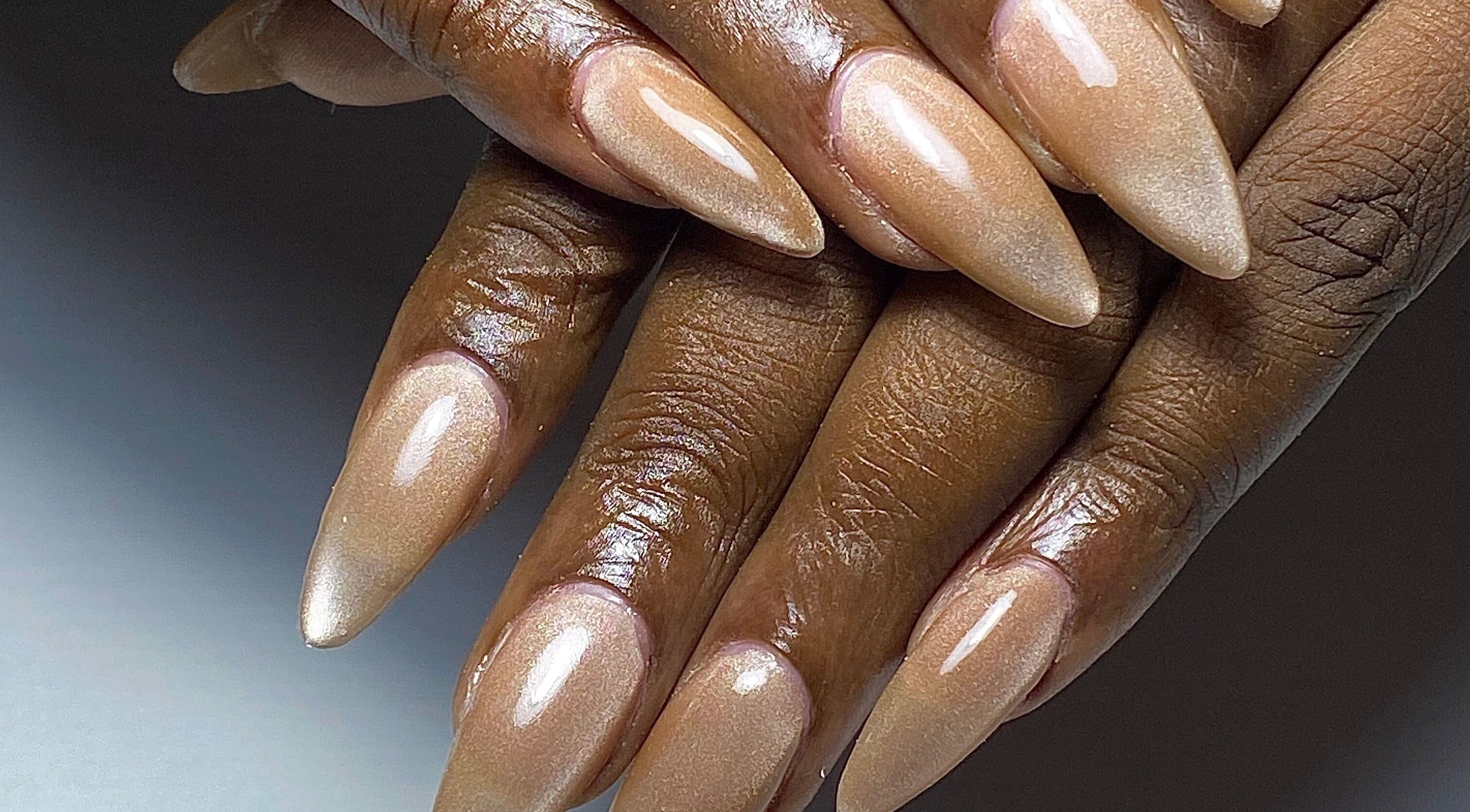 Glossy nail art in Paramaribo, Paramaribo, SR featuring shiny nude stiletto nails.