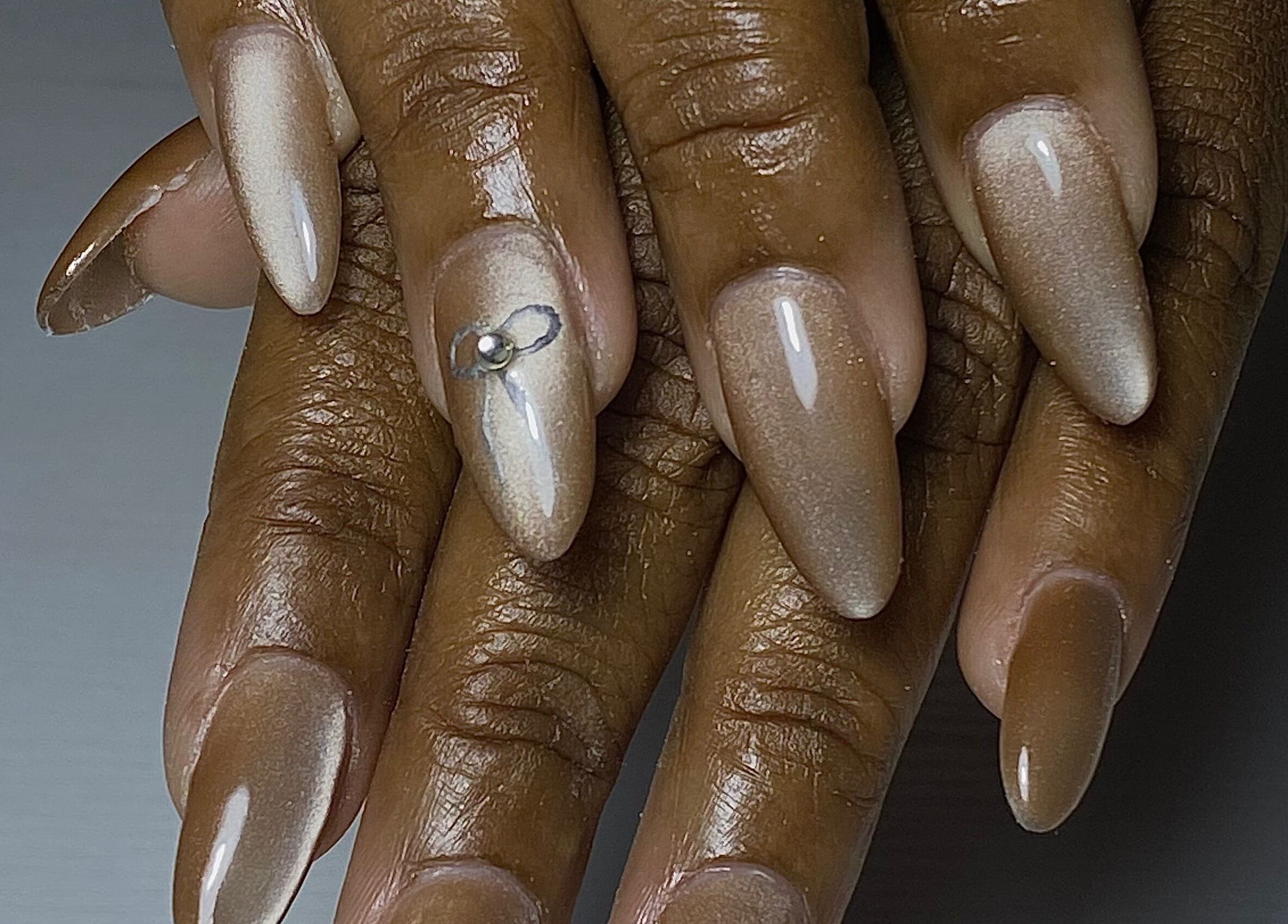 Stylish nude nails with a gem accent at Glossy in Paramaribo, Paramaribo, SR.