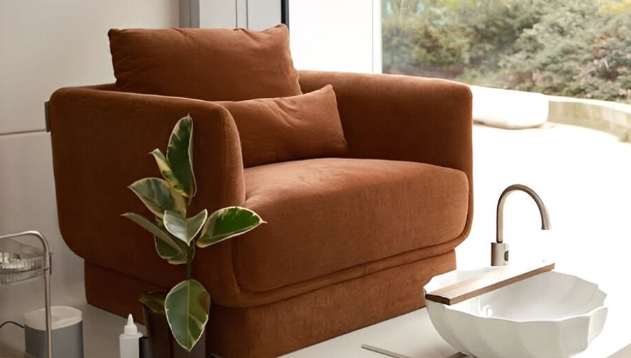 Cozy brown chair and modern basin at XYZ Beauty Lab, London, England, GB, offering a tranquil relaxation spot.
