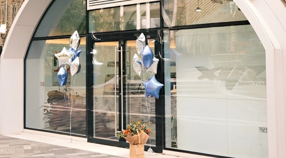 Front of XYZ Beauty Lab in London, England, GB with star-shaped balloons and a welcoming bouquet.