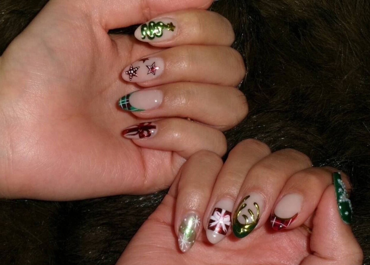 Colorful festive nail art at XYZ Beauty Lab, London, England, GB showcasing intricate holiday designs.