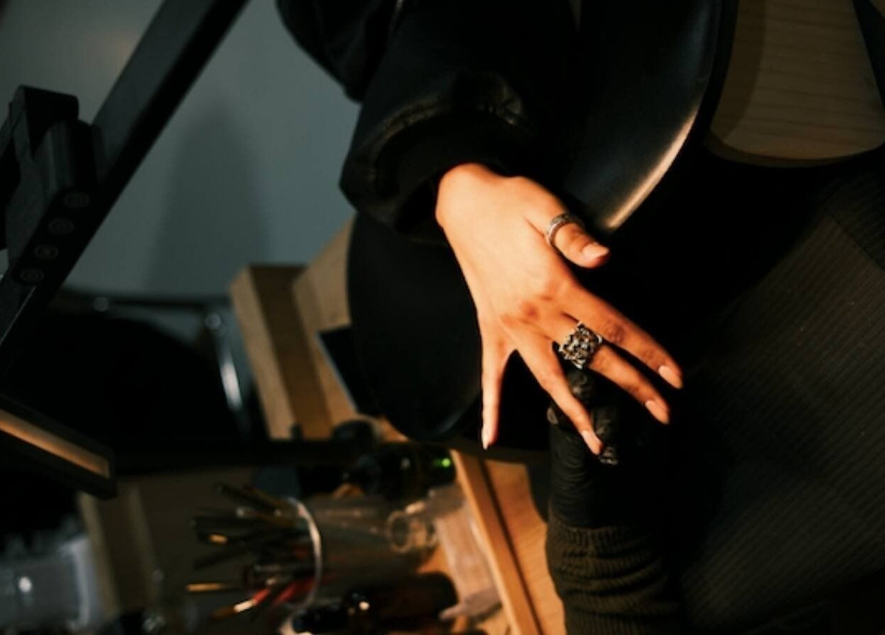 Glamorous hand receiving nail treatment at XYZ Beauty Lab, London, England, GB.