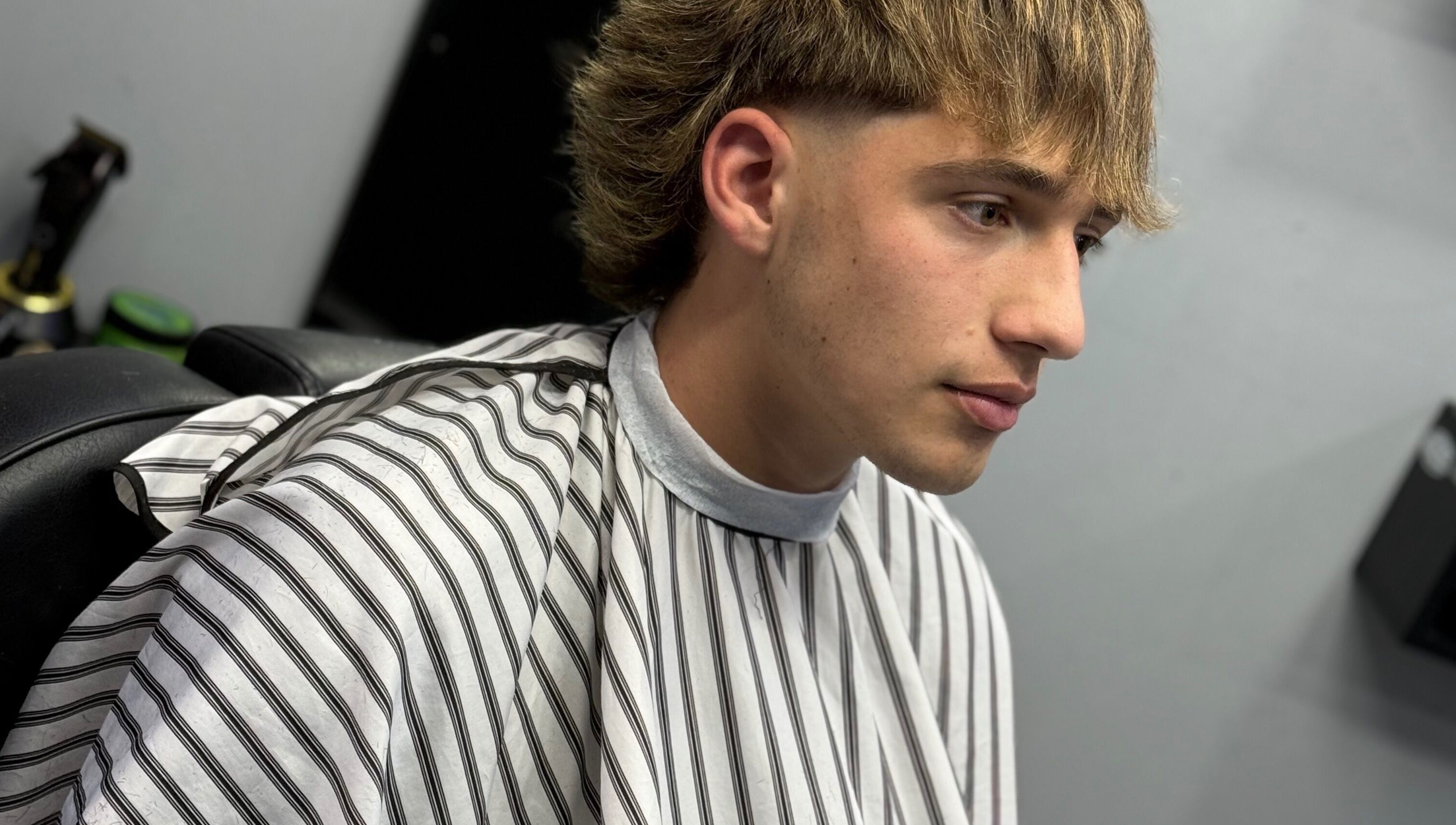 Joven en Southside Barbershop, Iuf, Santa Fe, AR con corte moderno y elegante.