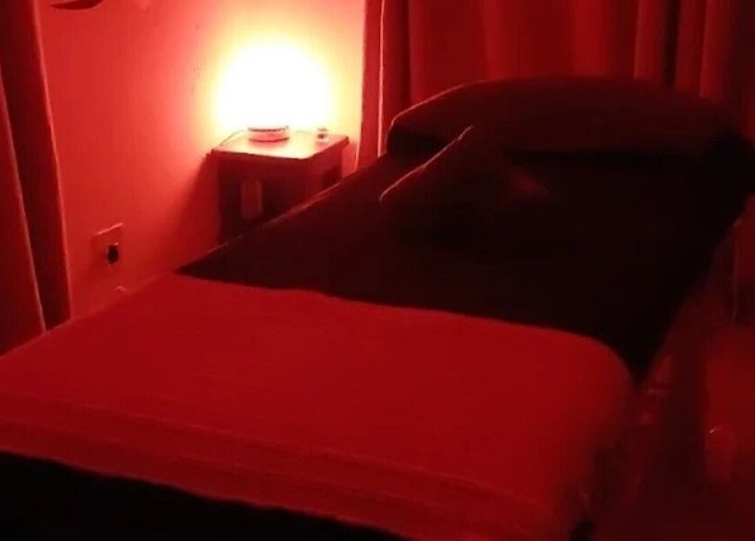 Relaxing massage room at Hazel Sensual Massage Therapist, Cape Town, Western Cape, ZA with ambient red lighting.