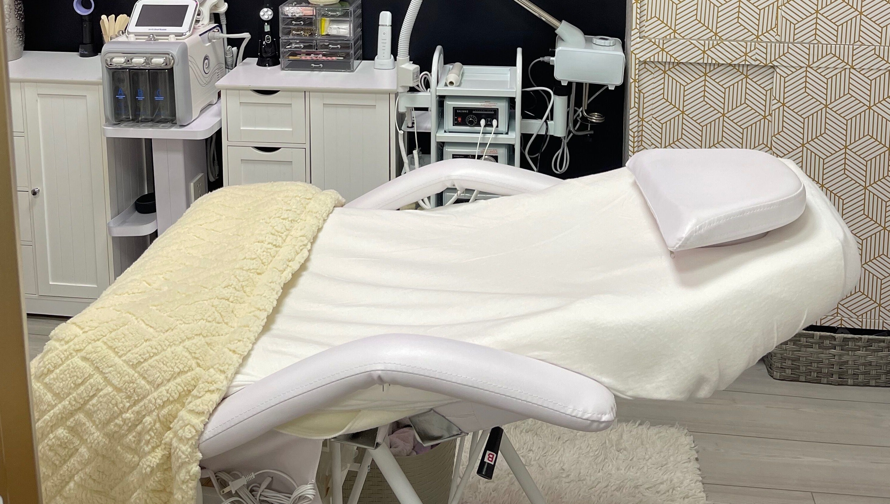 Luxurious treatment room at Alta Beauty, Winter Garden, Florida, US, featuring modern facial equipment and a plush bed.