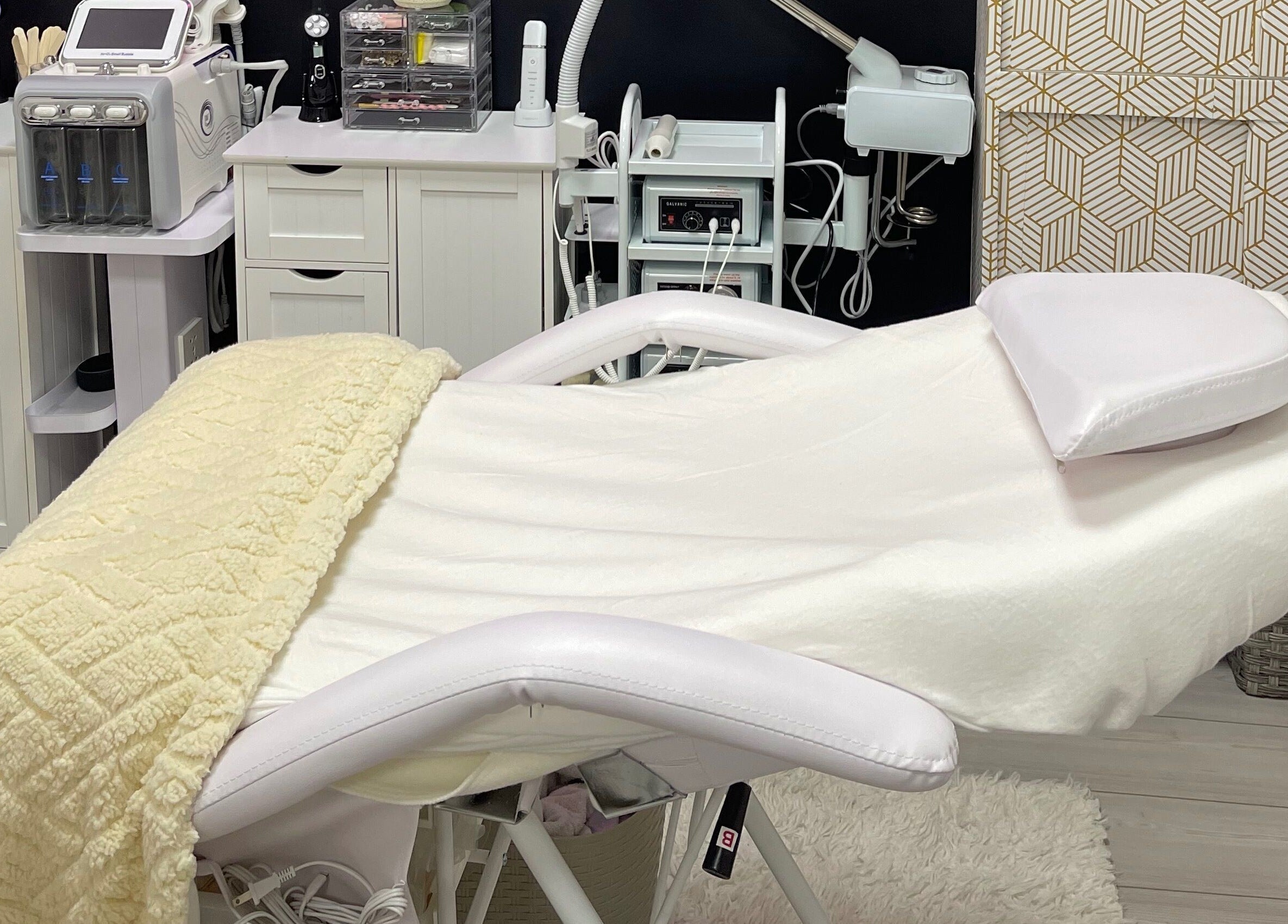 Luxurious treatment room at Alta Beauty, Winter Garden, Florida, US, featuring modern facial equipment and a plush bed.