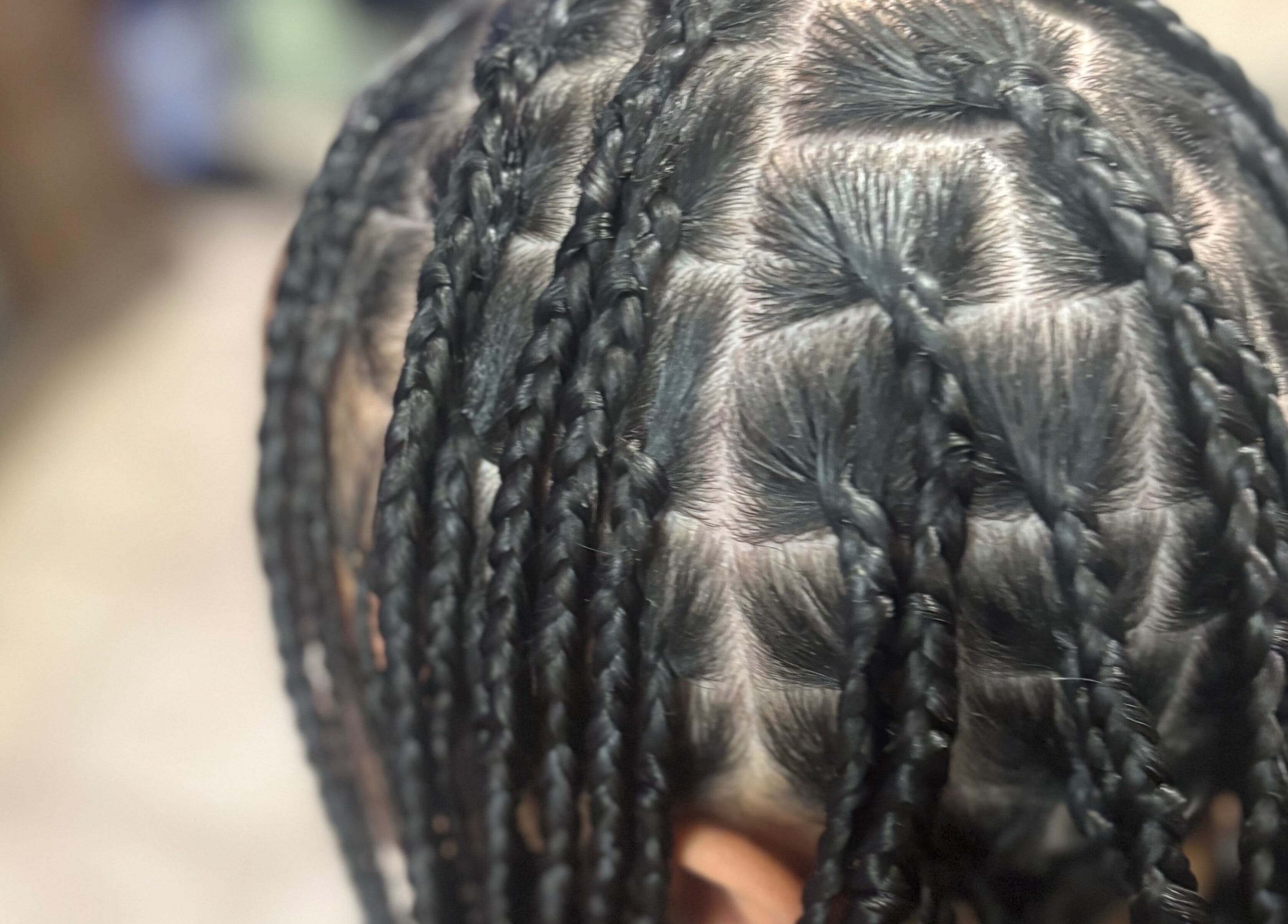Detailed cornrow braids at CrownedByLanii, El Mirage, Arizona, US showcasing expert styling.