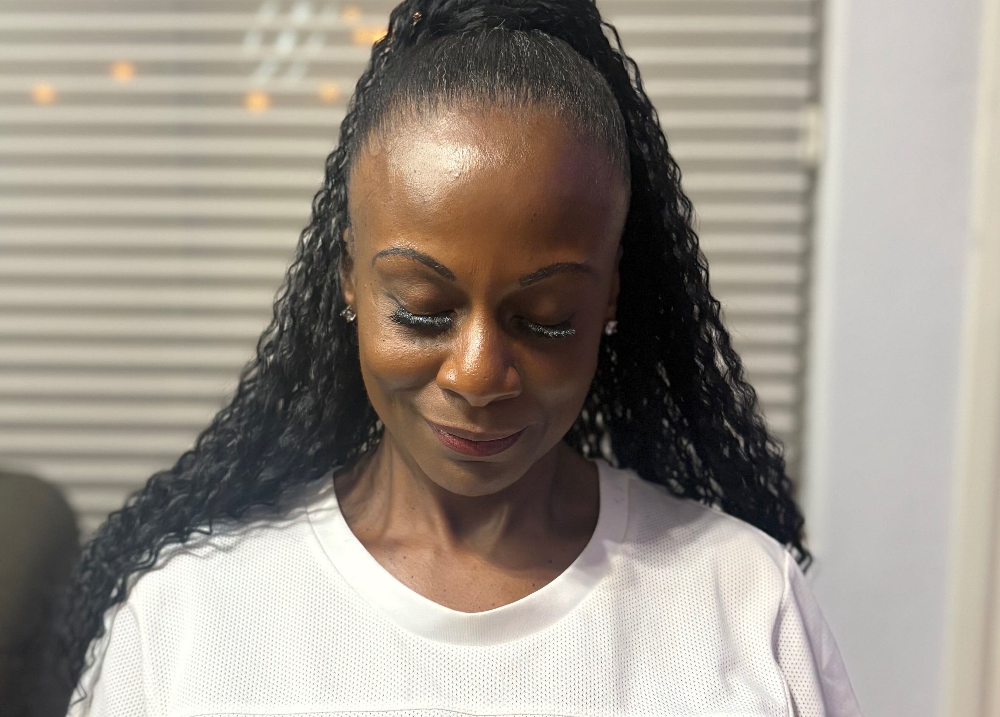 A client with styled hair at CrownedByLanii in El Mirage, Arizona, US, showing calm contentment.