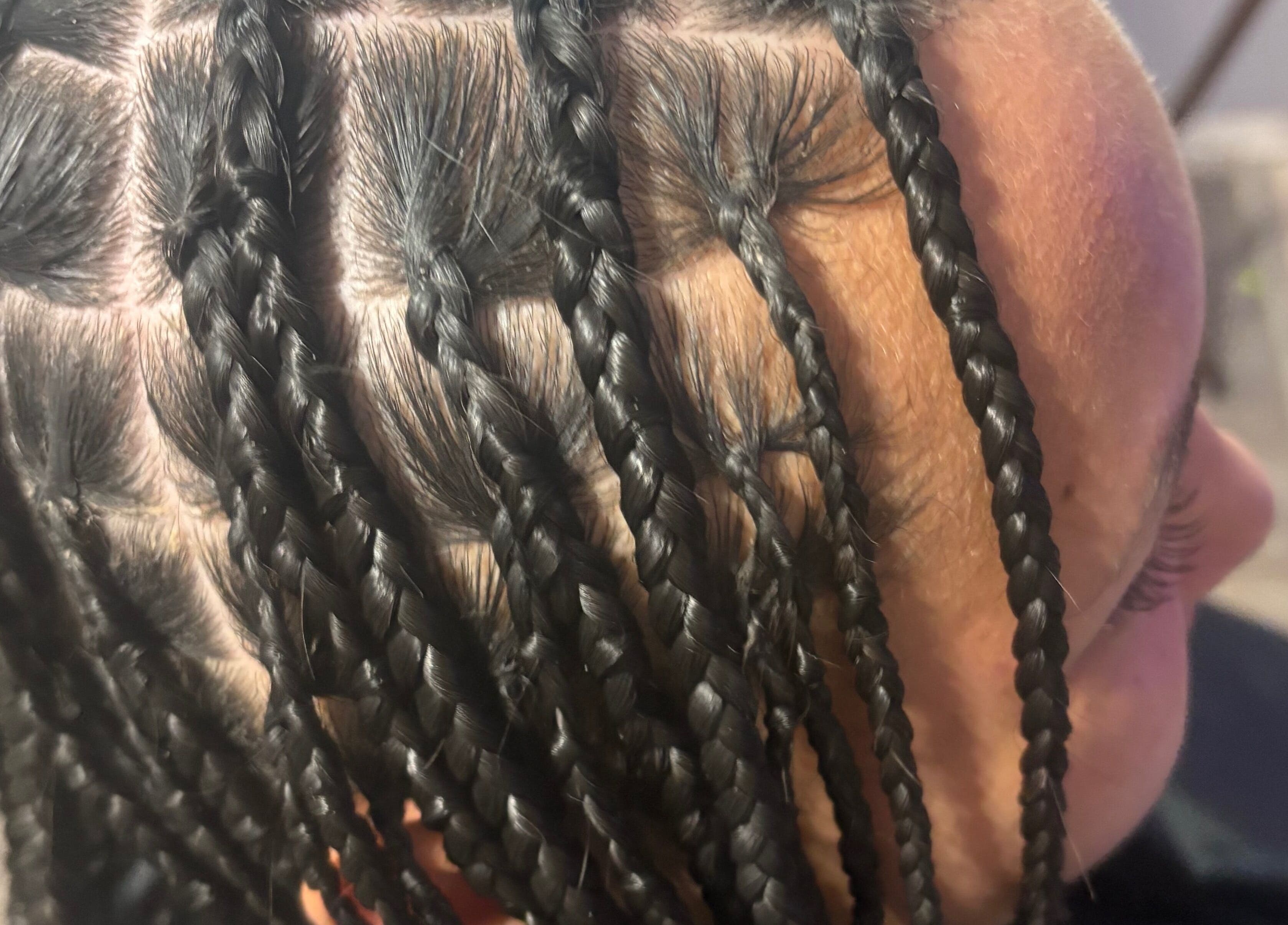 Close-up of intricate braiding at CrownedByLanii in El Mirage, Arizona, US, showcasing expert styling.