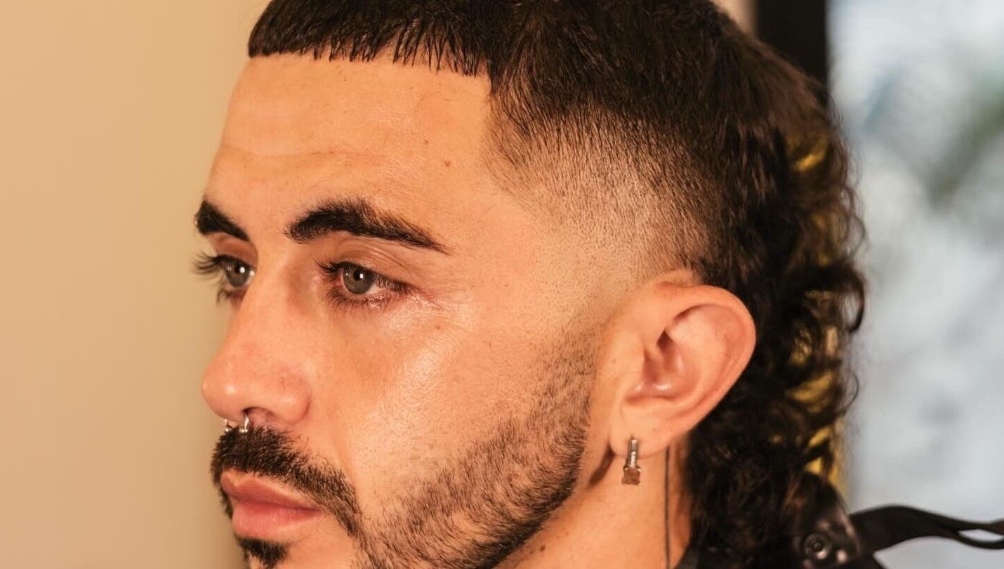 Side profile of a man with a stylish mullet haircut at nŌta studio, Tulum, Quintana Roo, MX.
