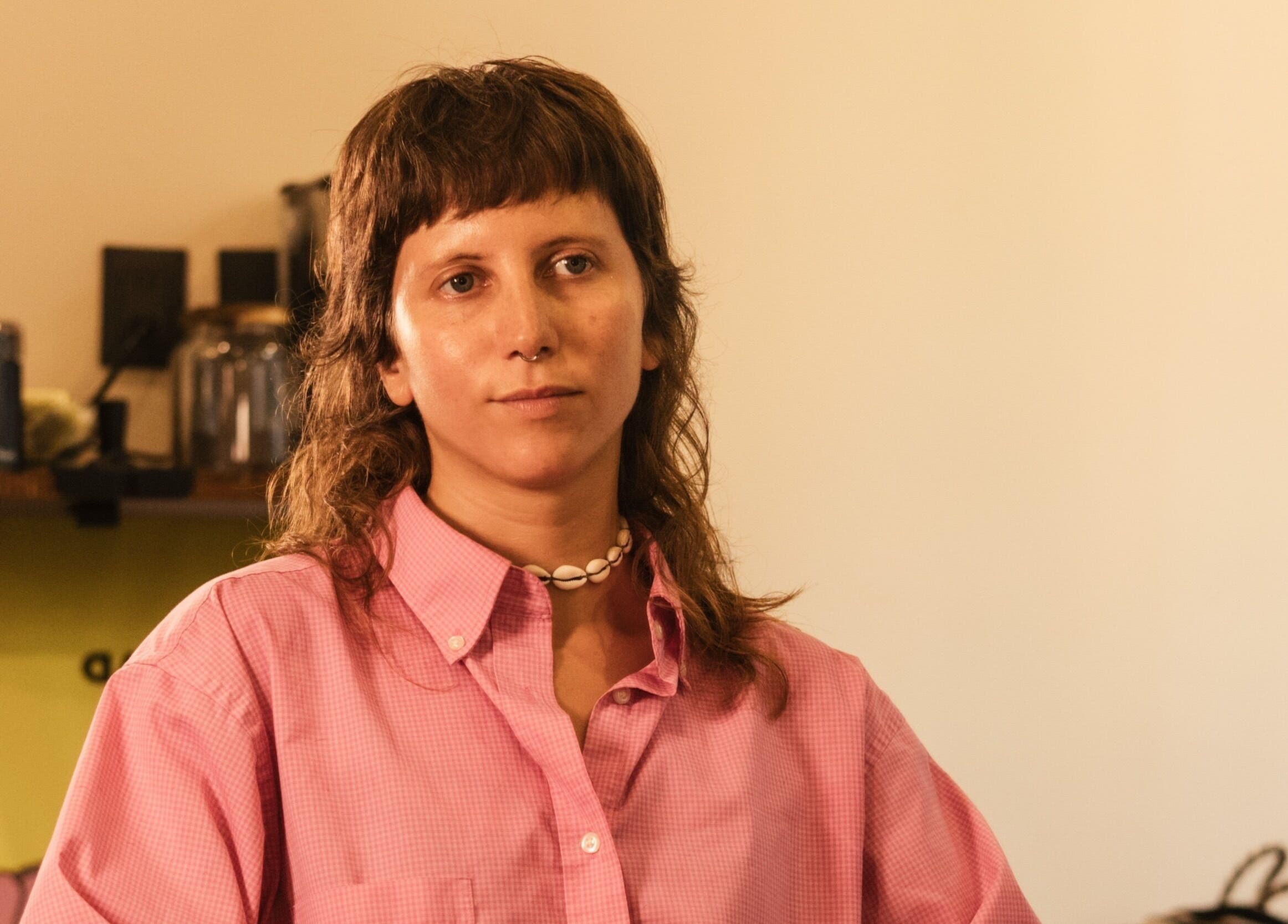 Individual in a pink shirt at nŌta studio, Tulum, Quintana Roo, MX, capturing a serene and creative vibe.