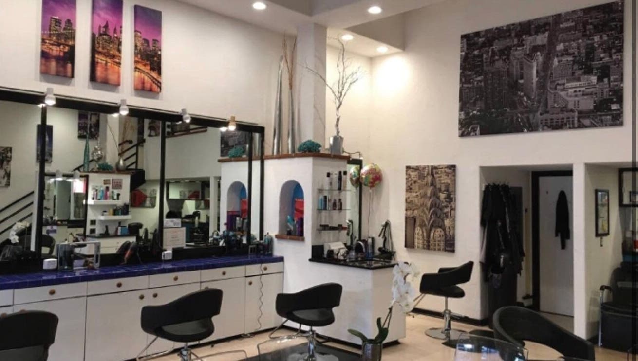 Modern interior of GET SMART KUTZ salon in Memphis, Tennessee, US featuring stylish chairs and elegant decor.