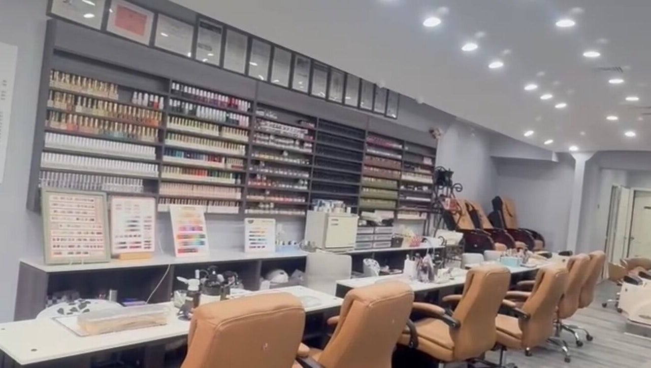 Interior view of Meiko Nail Spa, New York, showcasing nail polish displays and cozy seating.