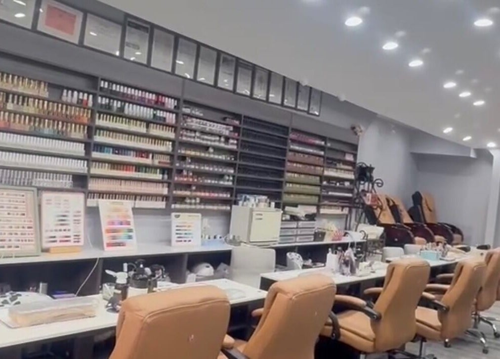 Interior view of Meiko Nail Spa, New York, showcasing nail polish displays and cozy seating.