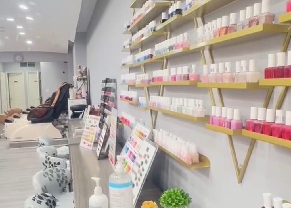 Inside Meiko Nail Spa in New York, shelves of vibrant nail polish create a welcoming and stylish atmosphere.