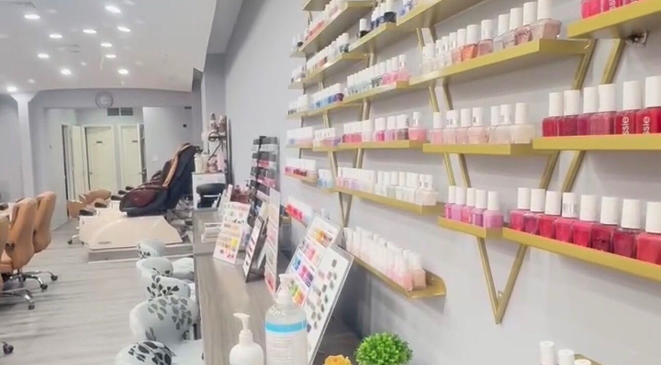 Inside Meiko Nail Spa in New York, shelves of vibrant nail polish create a welcoming and stylish atmosphere.
