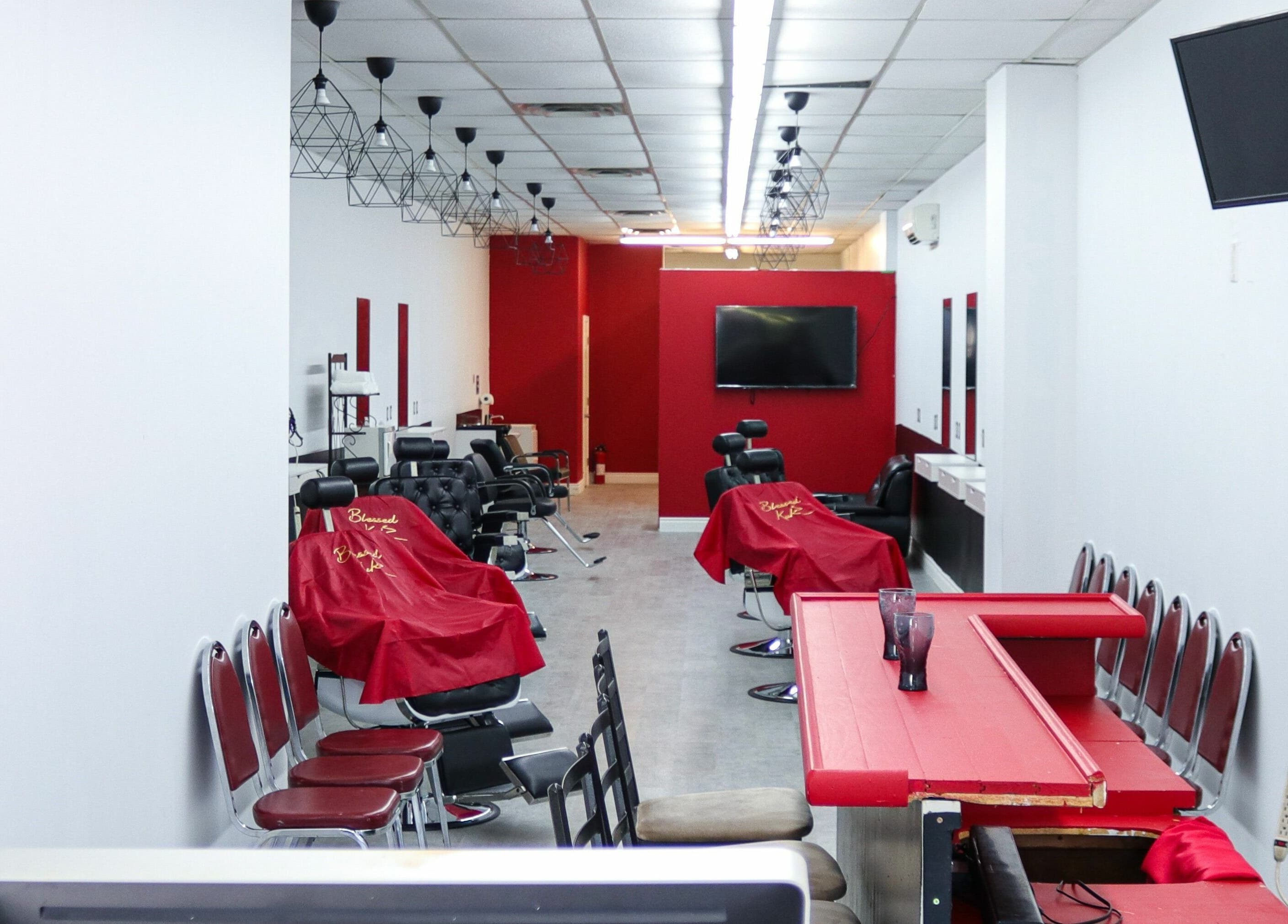 Interior view of Blessed Kutz salon in Whitby, Ontario, CA, showcasing modern chairs and a sleek design.