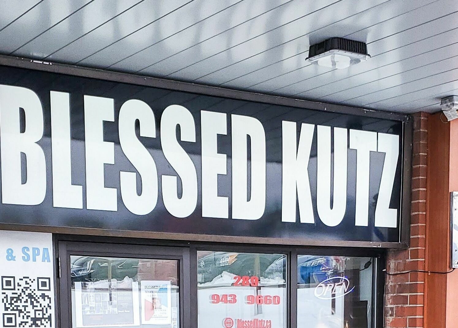 Front view of Blessed Kutz signage in Whitby, Ontario, CA, showcasing its unique branding.