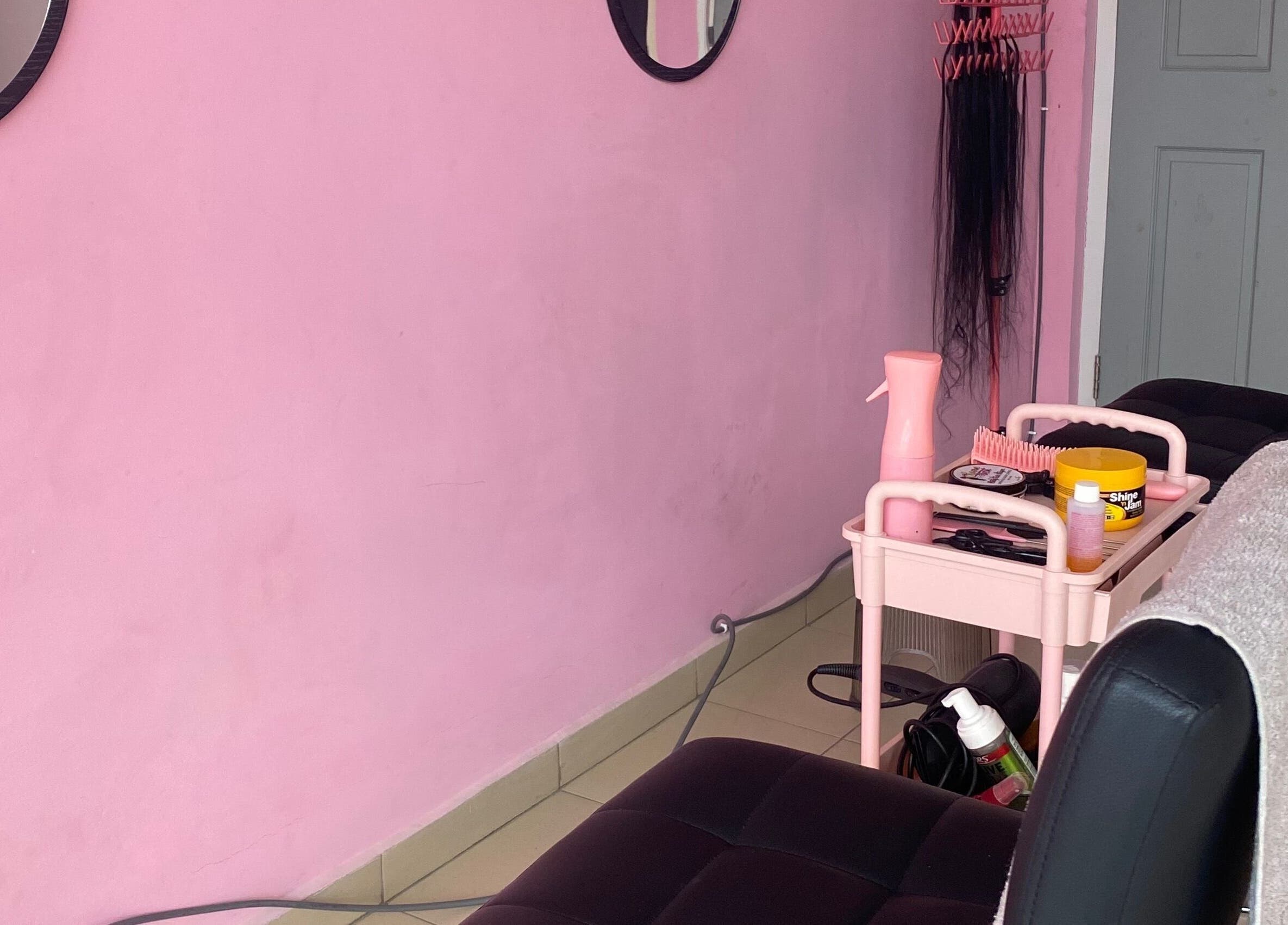 Cozy interior of DaintyLadies BeautySpot in Paramaribo, Paramaribo, SR with pink decor and salon tools.