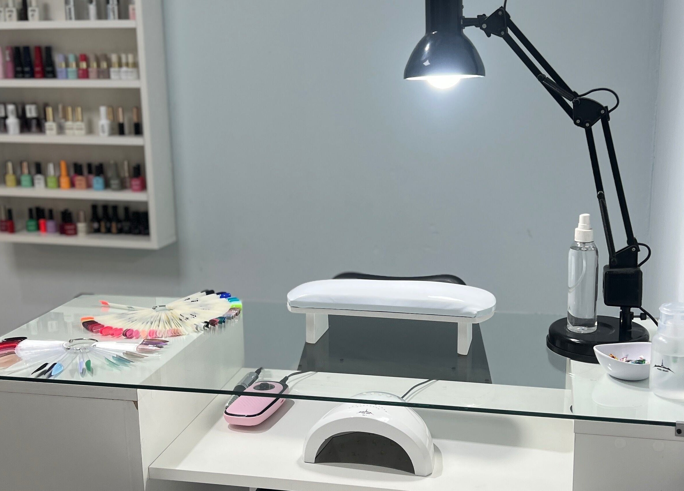 Nail treatment station at Marga Studio in Resistencia, Chaco, AR with tools and polish display.