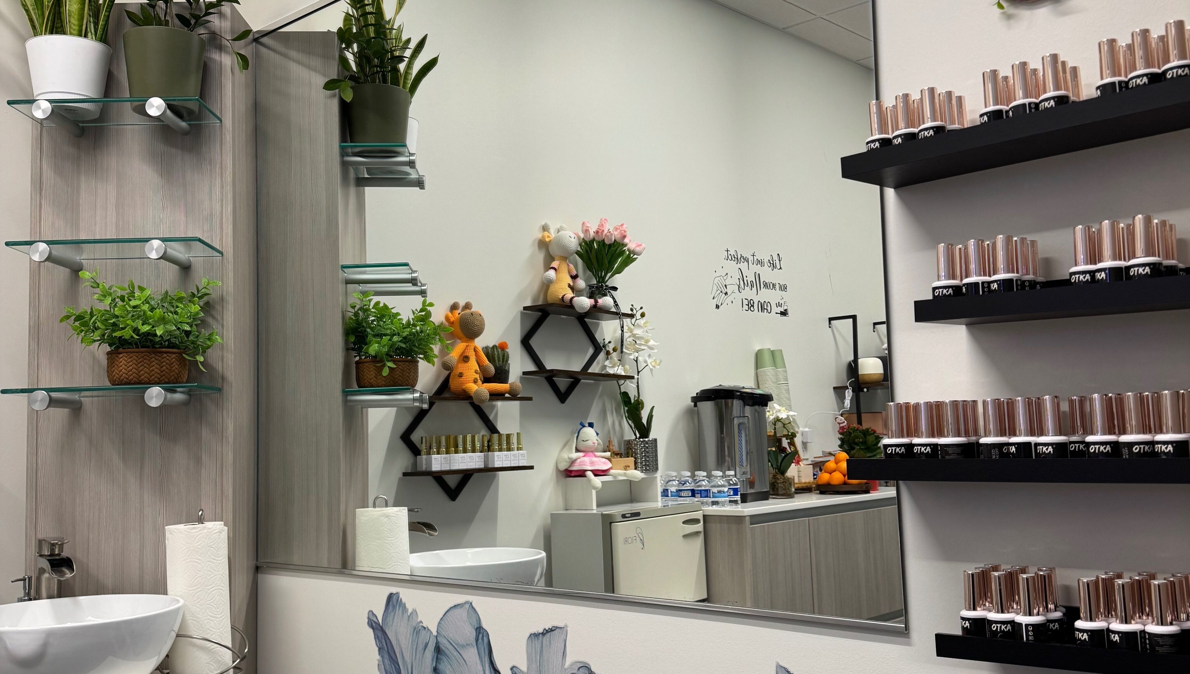 Stylish interior of Ivy's nails, Santa Clara, California, US with elegant decor, plants, and nail polish display.