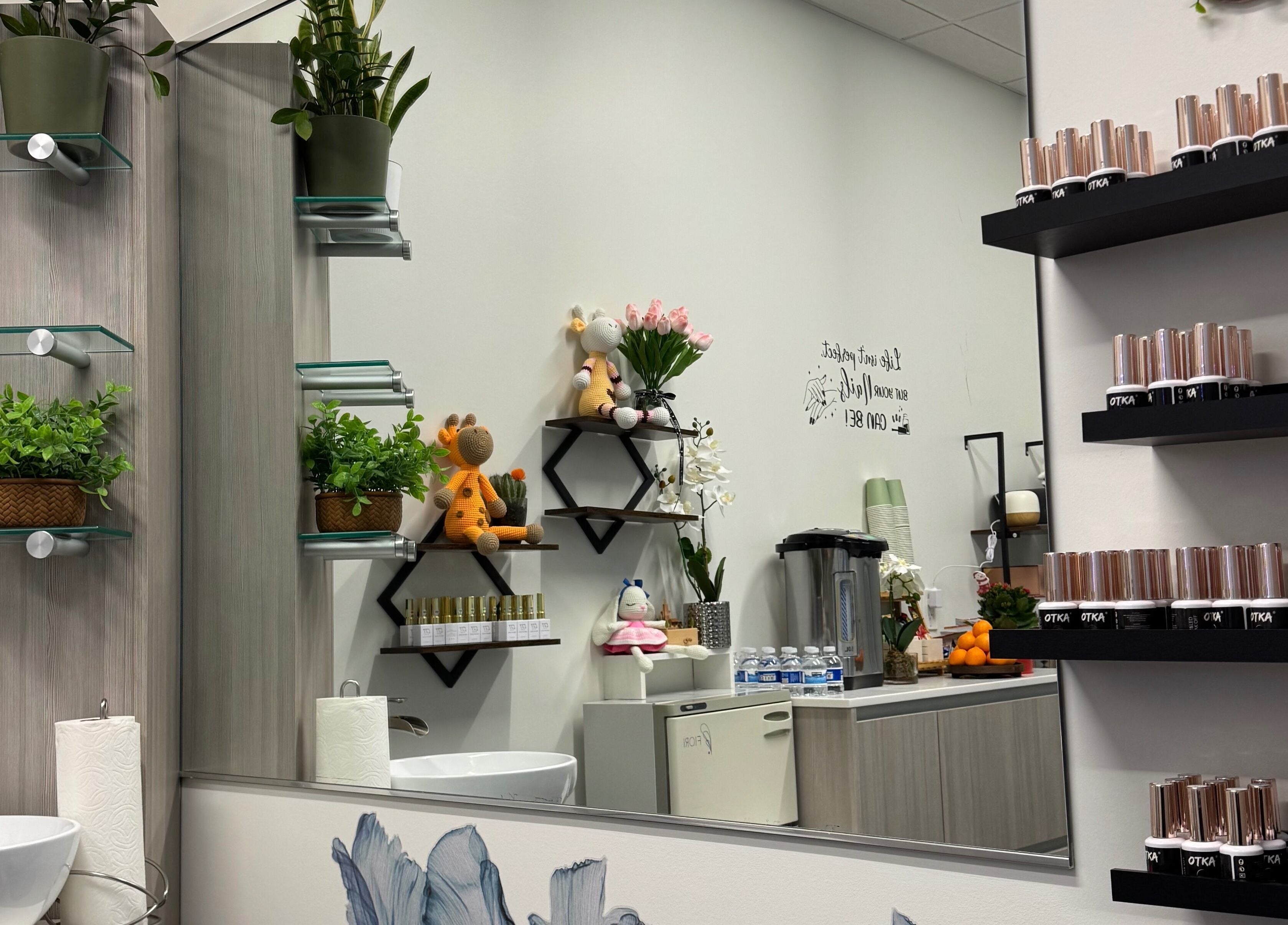 Stylish interior of Ivy's nails, Santa Clara, California, US with elegant decor, plants, and nail polish display.