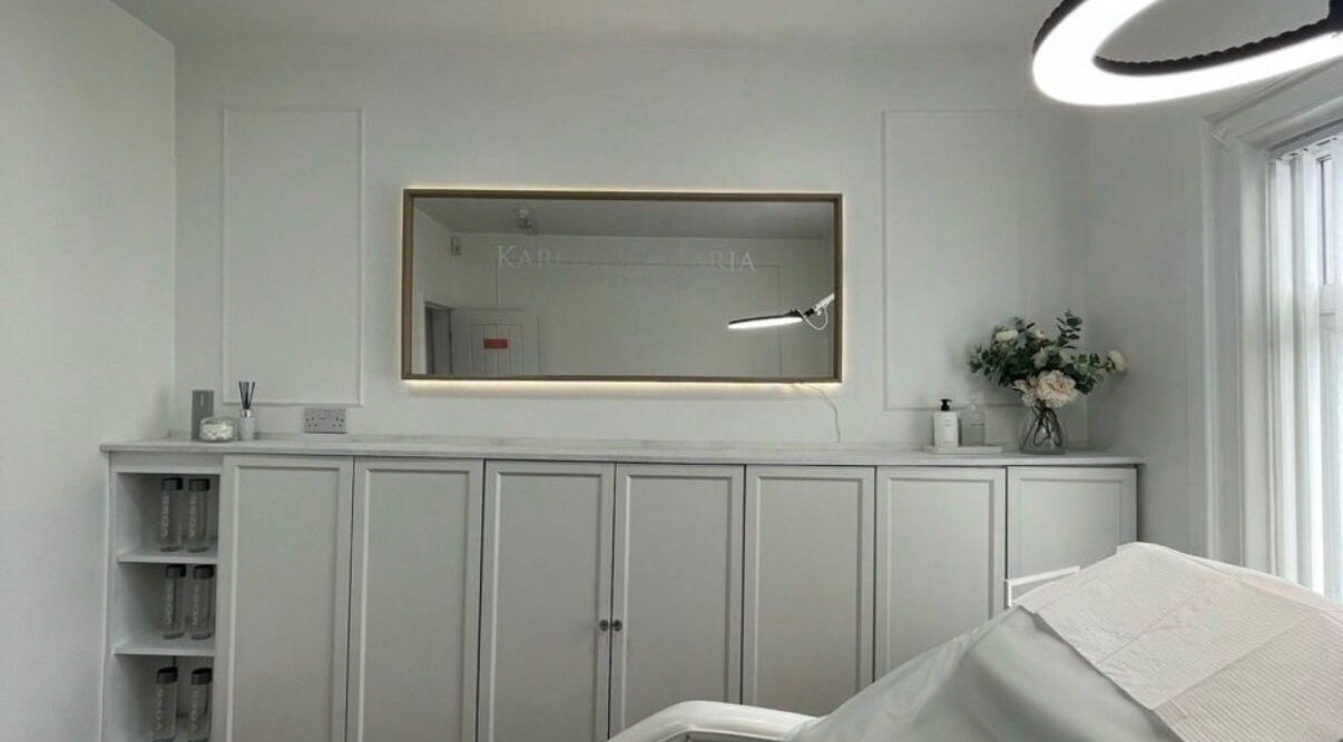 Elegant beauty treatment room at TheBrowBabesx, Talke, England, GB, with calm white decor and a large mirror.