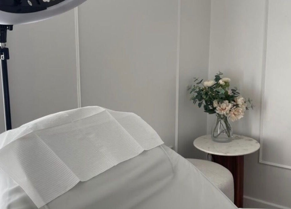 Calm treatment room at TheBrowBabesx, Talke, England, GB, featuring a massage bed and elegant floral decor.