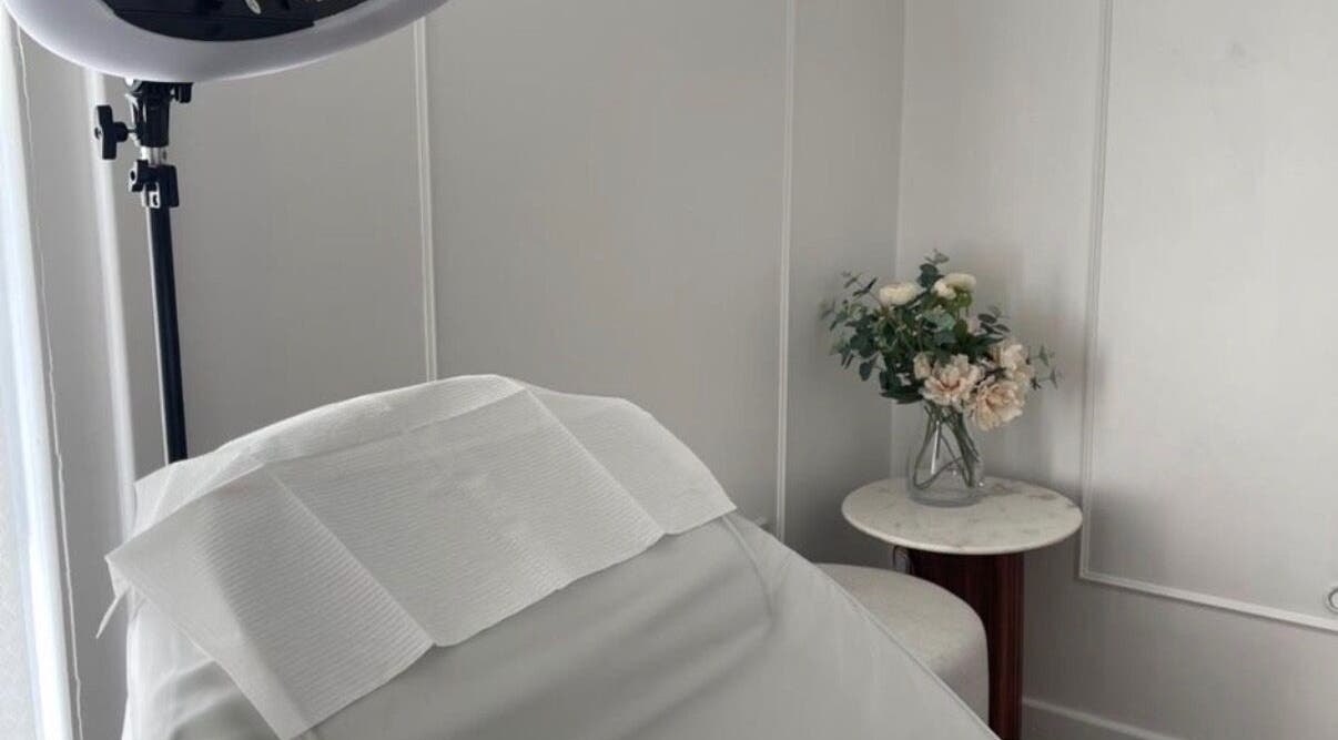 Calm treatment room at TheBrowBabesx, Talke, England, GB, featuring a massage bed and elegant floral decor.