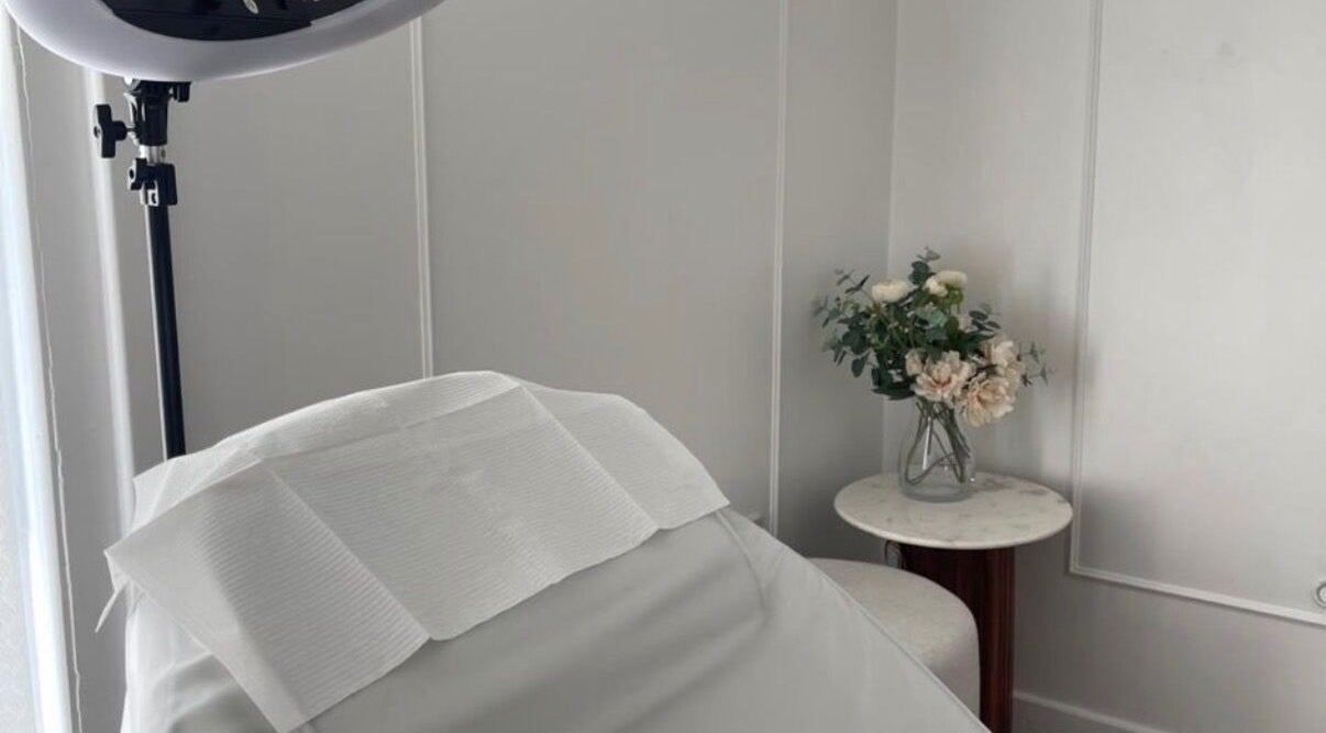 Calm treatment room at TheBrowBabesx, Talke, England, GB, featuring a massage bed and elegant floral decor.
