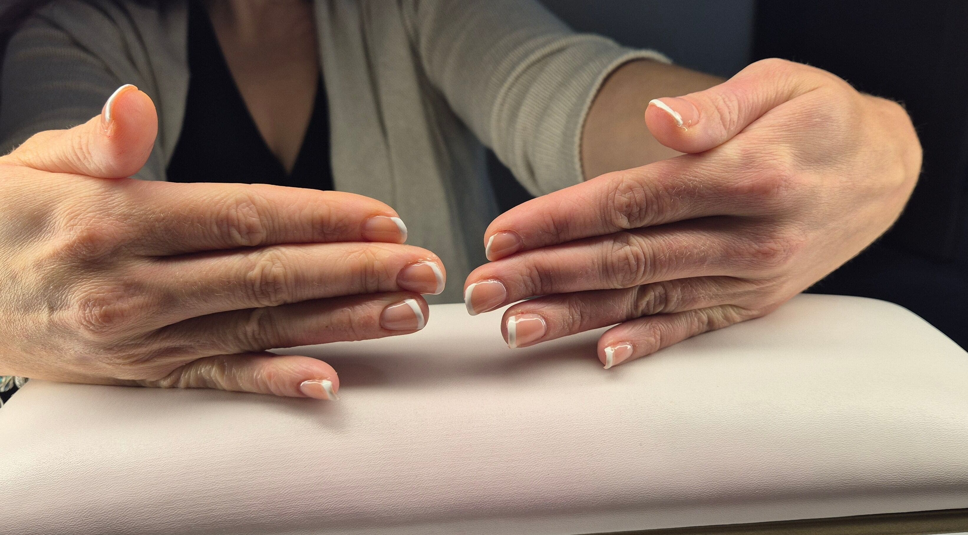 French manicured hands at Luna Lull, Douglas, IM showcasing elegant nail care.