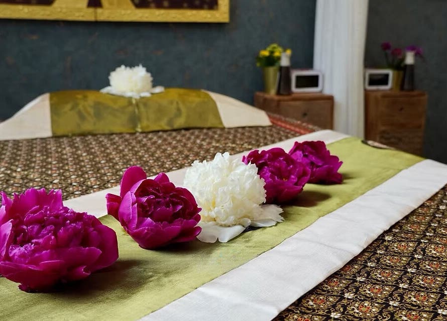 Relaxing spa bed with flowers at Absolute Thai Wellness, Luxembourg, LU, exuding tranquility.