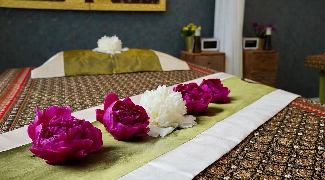 Relaxing spa bed with flowers at Absolute Thai Wellness, Luxembourg, LU, exuding tranquility.
