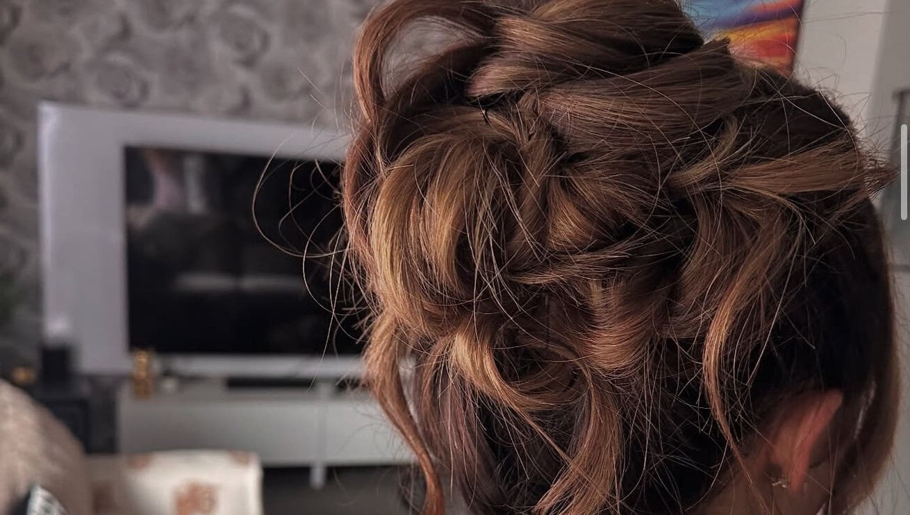 Stylish updo hairstyle at Hair by JC, Kilwinning, Scotland, GB. Perfect blend of elegance and charm.