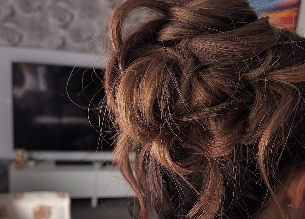 Stylish updo hairstyle at Hair by JC, Kilwinning, Scotland, GB. Perfect blend of elegance and charm.