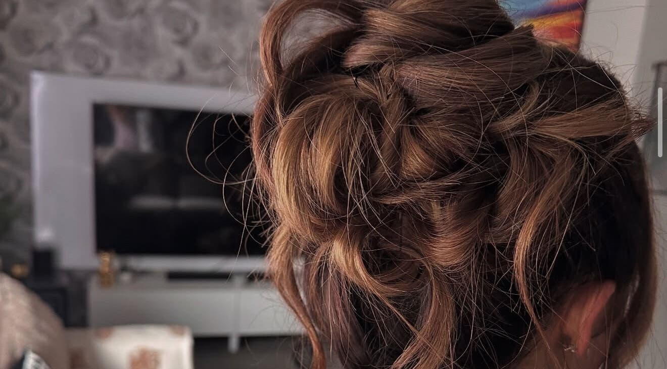 Stylish updo hairstyle at Hair by JC, Kilwinning, Scotland, GB. Perfect blend of elegance and charm.